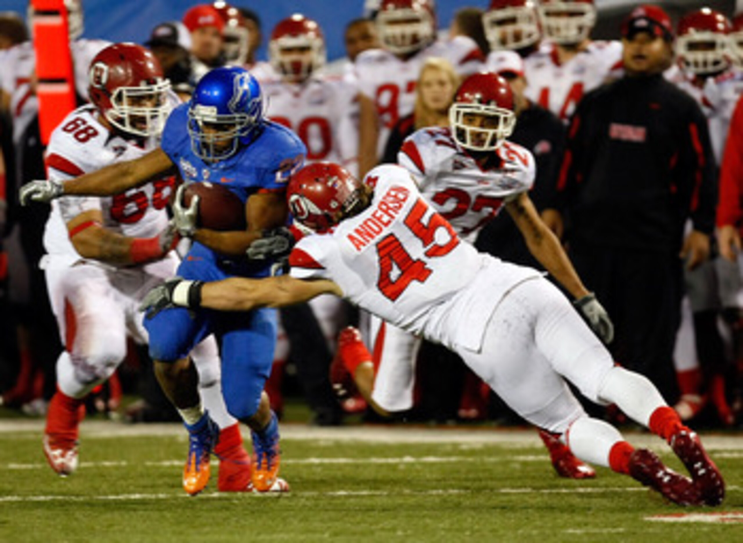 LAS VEGAS, NV - DECEMBER 22:  Doug Martin #22 of the Boise State Broncos is tackled by Boo Andersen #45 of the Utah Utes during the MAACO Bowl Las Vegas at Sam Boyd Stadium December 22, 2010 in Las Vegas, Nevada. Boise State won 26-3.  (Photo by Ethan Mil