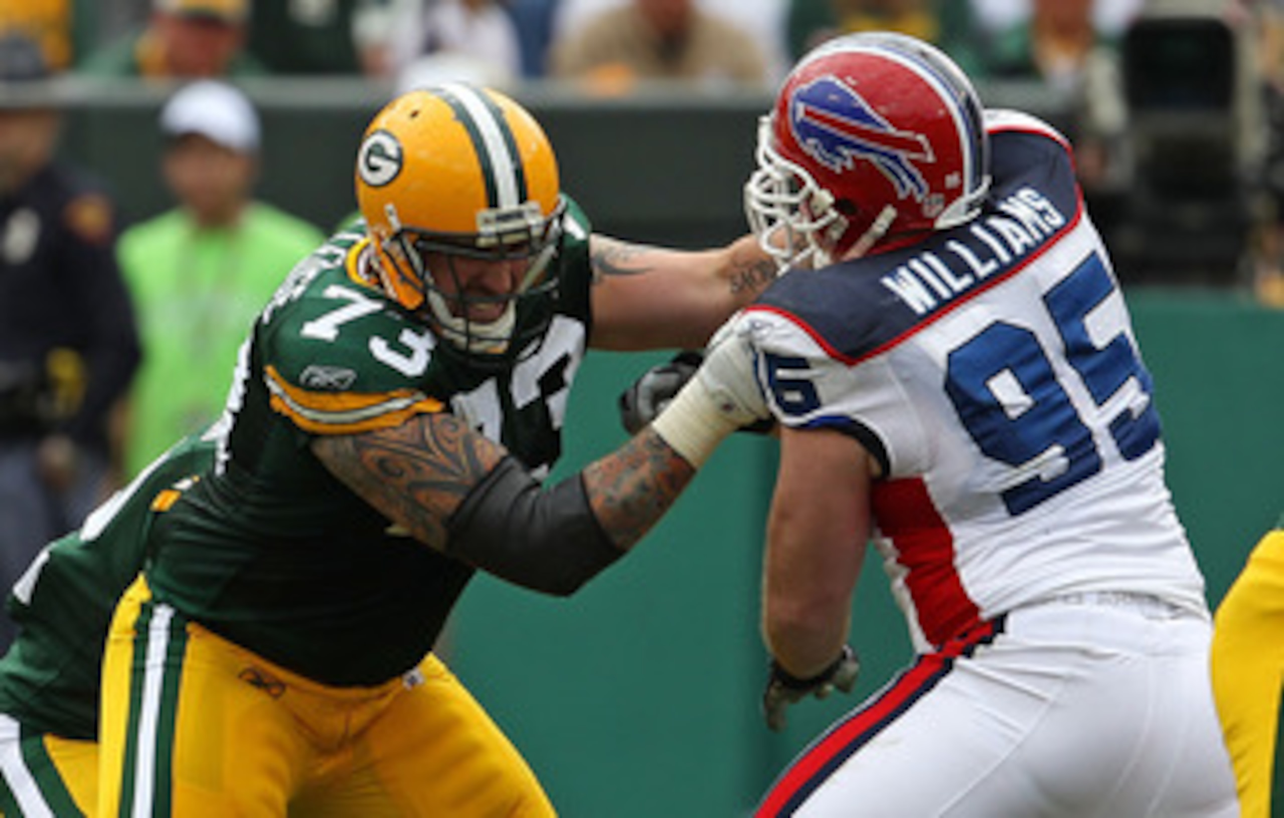 GREEN BAY, WI - SEPTEMBER 19: Daryn Colledge #73 of the Green Bay Packers blocks Kyle Williams #95 of the Buffalo Bills at Lambeau Field on September 19, 2010 in Green Bay, Wisconsin. The Packers defeated the Bills 34-7. (Photo by Jonathan Daniel/Getty Im