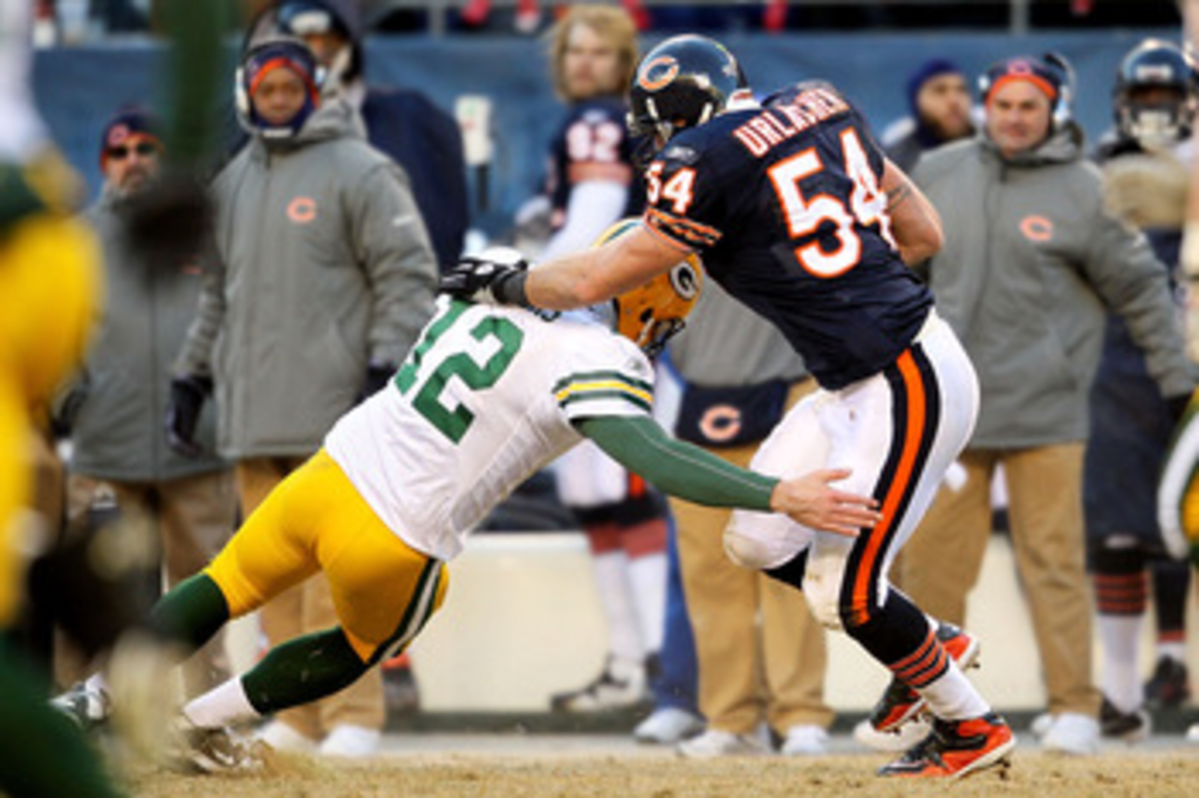 CHICAGO, IL - JANUARY 23:  Linebacker Brian Urlacher #54 of the Chicago Bears is tackled by quarterback Aaron Rodgers #12 of the Green Bay Packers after Urlacher runs an interception 39-yards in the third quarter in the NFC Championship Game at Soldier Fi