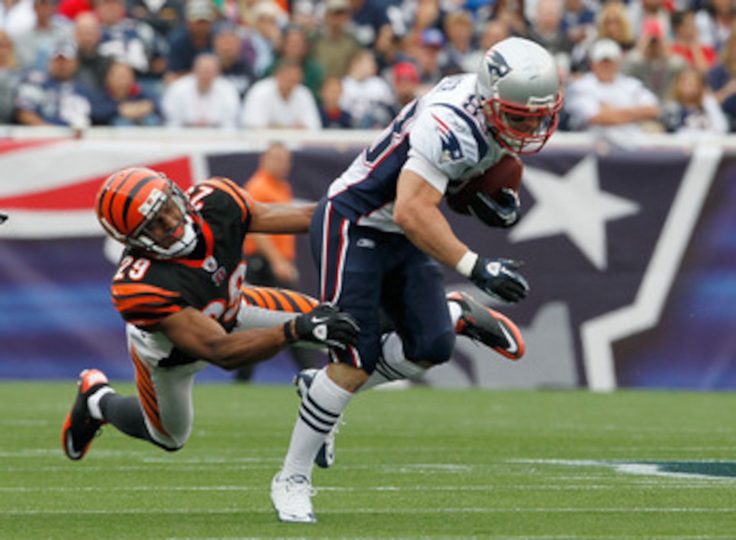 FOXBORO, MA - SEPTEMBER 12:  Wes Welker #83 of the New England Patriots gains yardage despite the defense of Leon Hall #29 of the Cincinnati Bengals during during the NFL season opener at Gillette Stadium on September 12, 2010 in Foxboro, Massachusetts. (