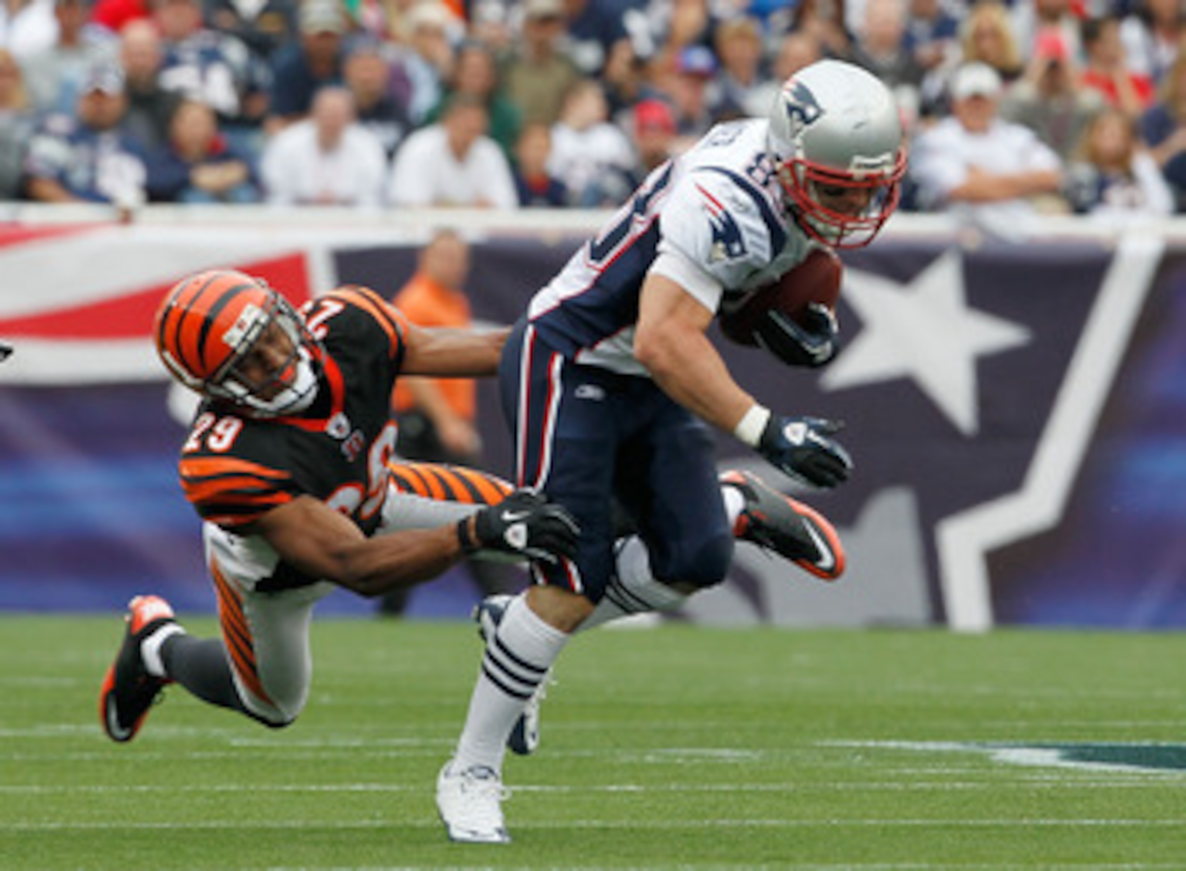 FOXBORO, MA - SEPTEMBER 12:  Wes Welker #83 of the New England Patriots gains yardage despite the defense of Leon Hall #29 of the Cincinnati Bengals during during the NFL season opener at Gillette Stadium on September 12, 2010 in Foxboro, Massachusetts. (
