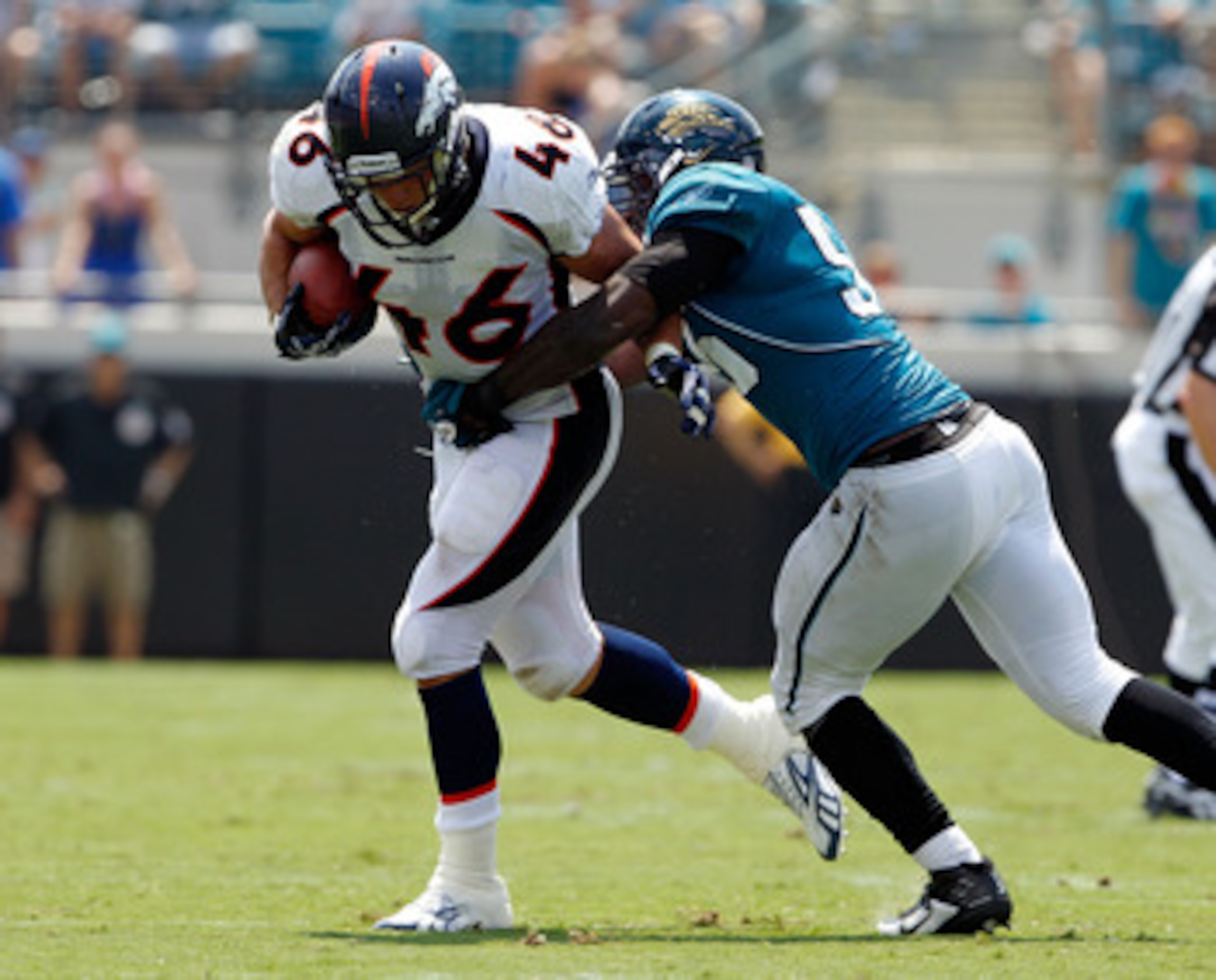 JACKSONVILLE, FL - SEPTEMBER 12:  Terrance Knighton #96 of the Jacksonville Jaguars attempts to tackle Spencer Larsen #46 of the Denver Broncos during the NFL season opener game at EverBank Field on September 12, 2010 in Jacksonville, Florida.  (Photo by 