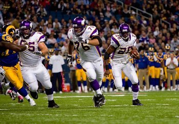 ST. LOUIS - OCTOBER 11:  Adrian Peterson #28 of the Minnesota Vikings runs to his left toward the end zone in front of teammates Steve Hutchinson #76 and John Sullivan #65 during their NFL game against the St. Louis Rams at the Edward Jones Dome on Octobe