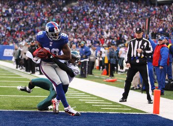 EAST RUTHERFORD, NJ - DECEMBER 19:  Hakeem Nicks #88 of the New York Giants scores a touchdown in the second quarter as Dimitri Patterson #23 of the Philadelphia Eagles defends during their game on December 19, 2010 at The New Meadowlands Stadium in East 