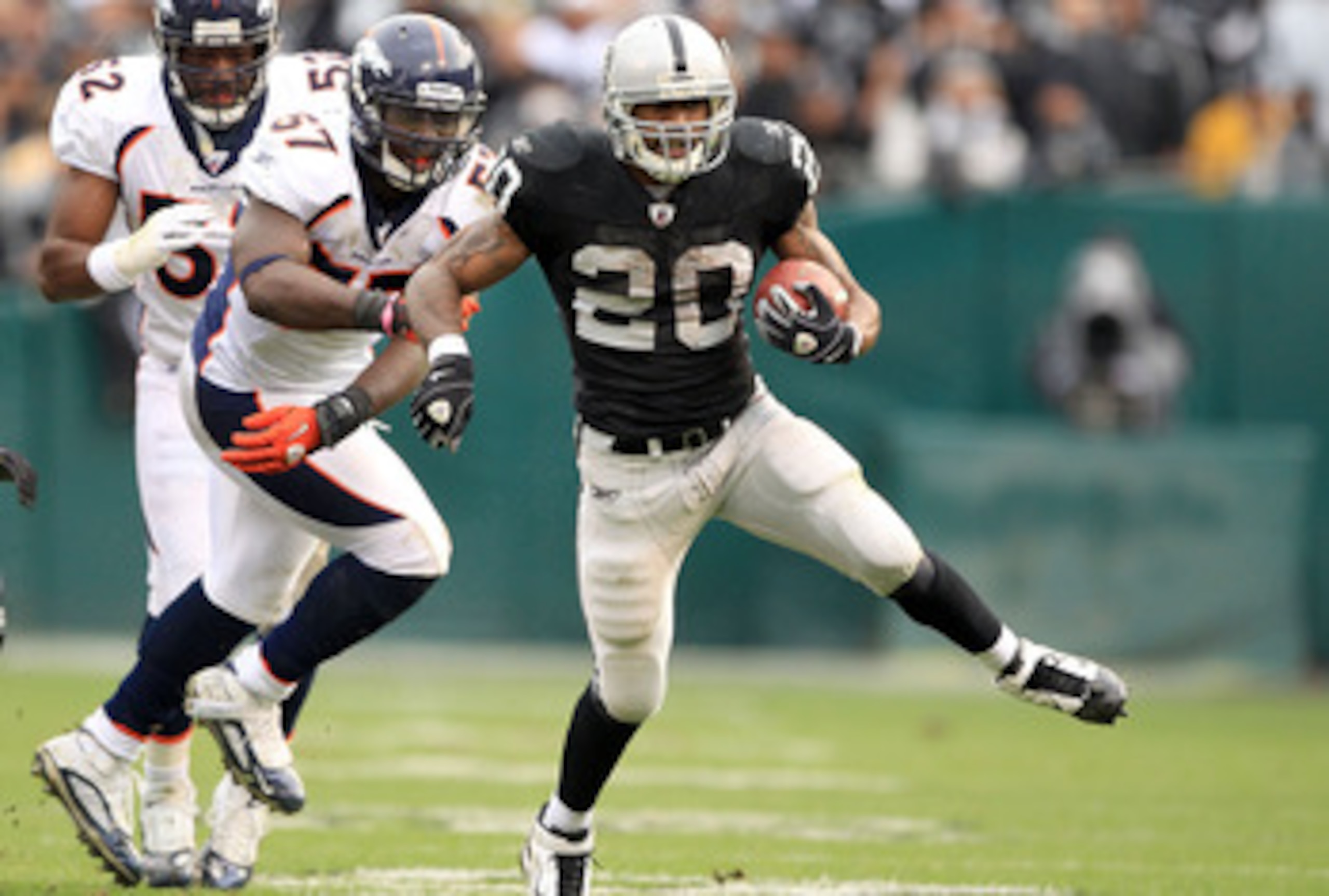 OAKLAND, CA - DECEMBER 19:  Darren McFadden #20 of the Oakland Raiders runs with the ball during their game against the Denver Broncos at Oakland-Alameda County Coliseum on December 19, 2010 in Oakland, California.  (Photo by Ezra Shaw/Getty Images)
