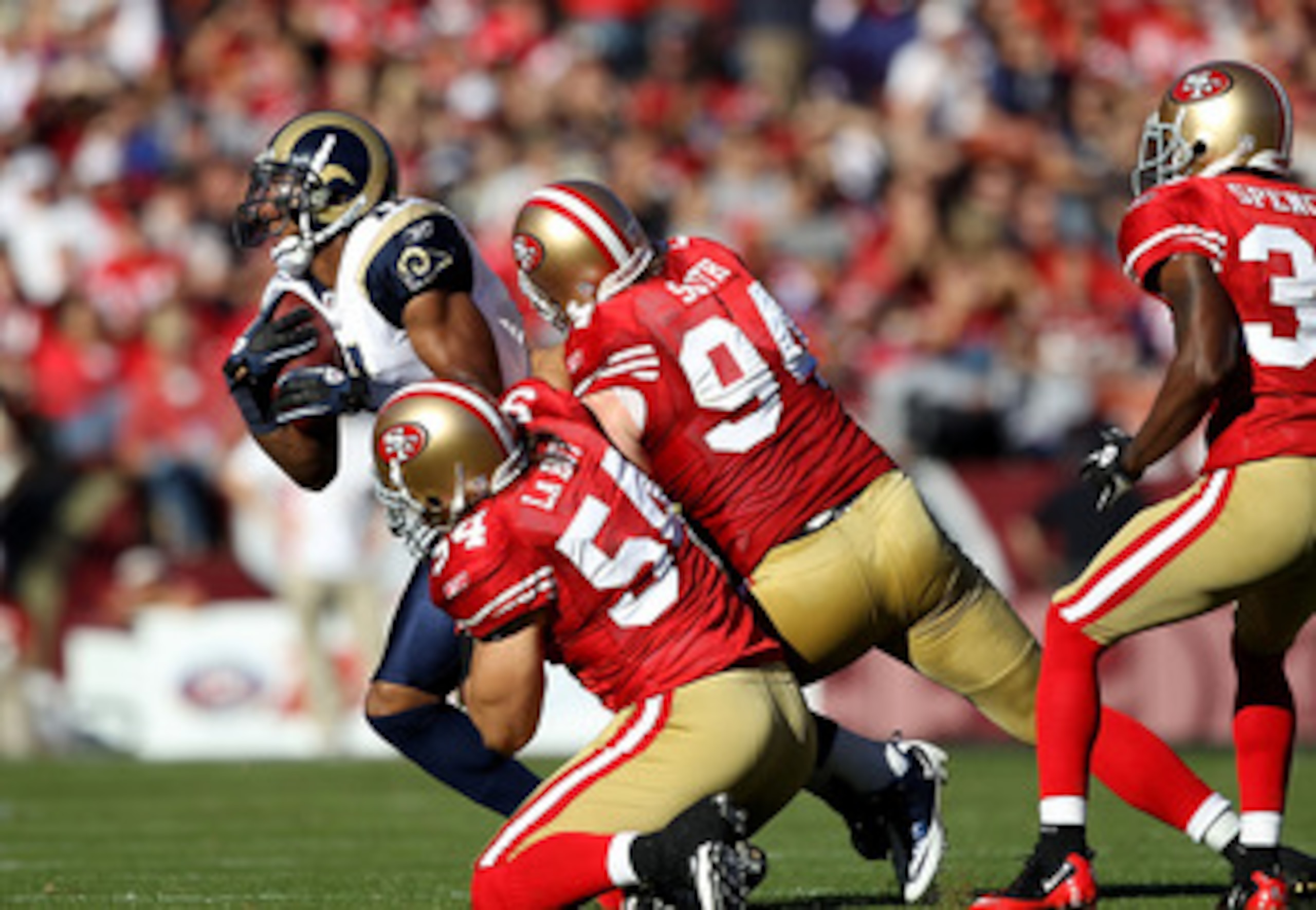 SAN FRANCISCO - NOVEMBER 14:  Brandon Gibson #11 of the St. Louis Rams is tackled by Travis LaBoy #54 and Justin Smith #94 of the San Francisco 49ers at Candlestick Park on November 14, 2010 in San Francisco, California.  (Photo by Ezra Shaw/Getty Images)