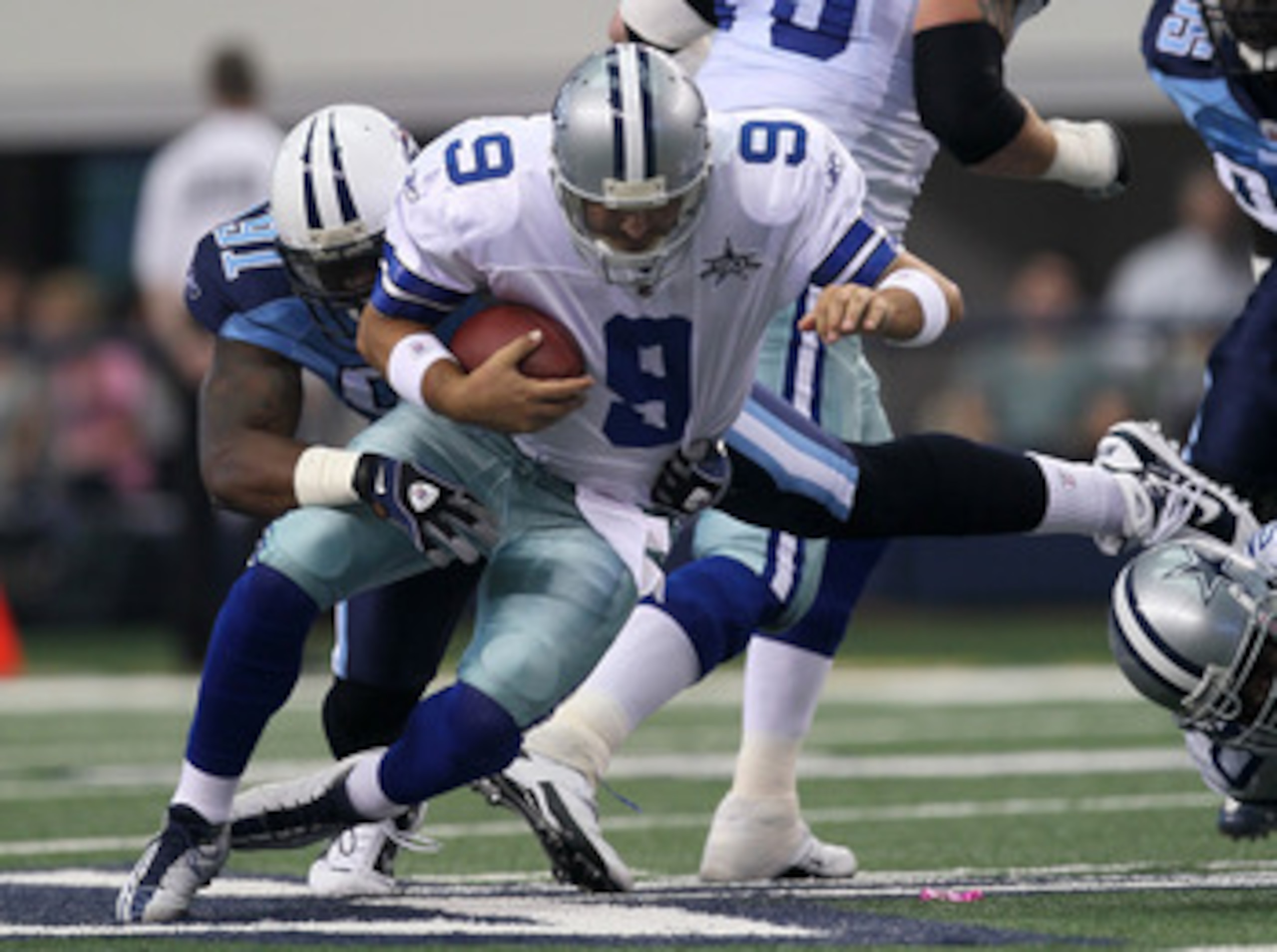 ARLINGTON, TX - OCTOBER 10:  Defensive tackle Jason Jones #91 of the Tennessee Titans sacks quarterback Tony Romo #9 of the Dallas Cowboys at Cowboys Stadium on October 10, 2010 in Arlington, Texas. (Photo by Stephen Dunn/Getty Images)