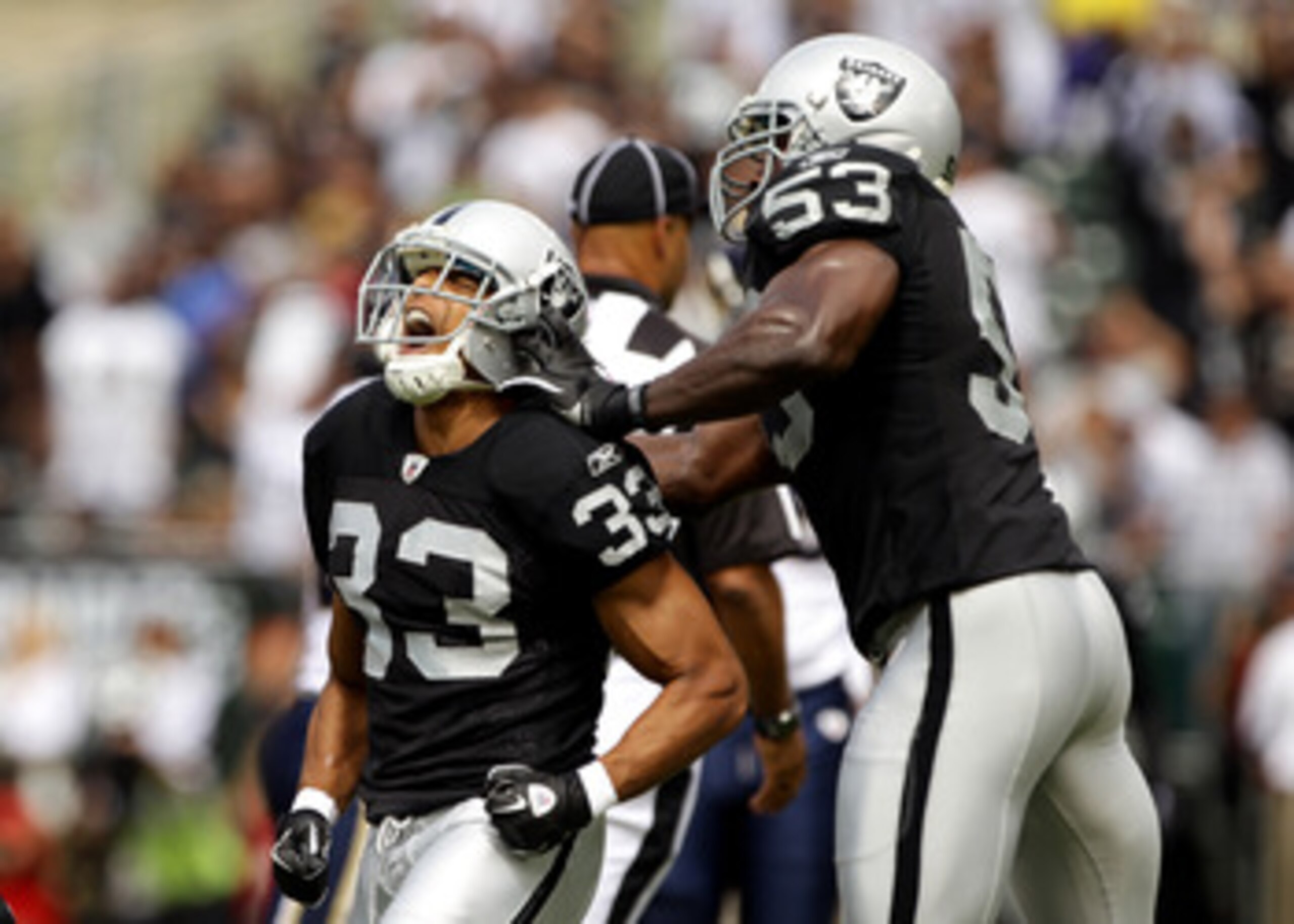 OAKLAND, CA - SEPTEMBER 19:  Tyvon Branch #33 is congratulated by Thomas Howard #52 of the Oakland Raiders after Branch sacked Sam Bradford #8 of the St. Louis Rams at the Oakland-Alameda County Coliseum on September 19, 2010 in Oakland, California.  (Pho
