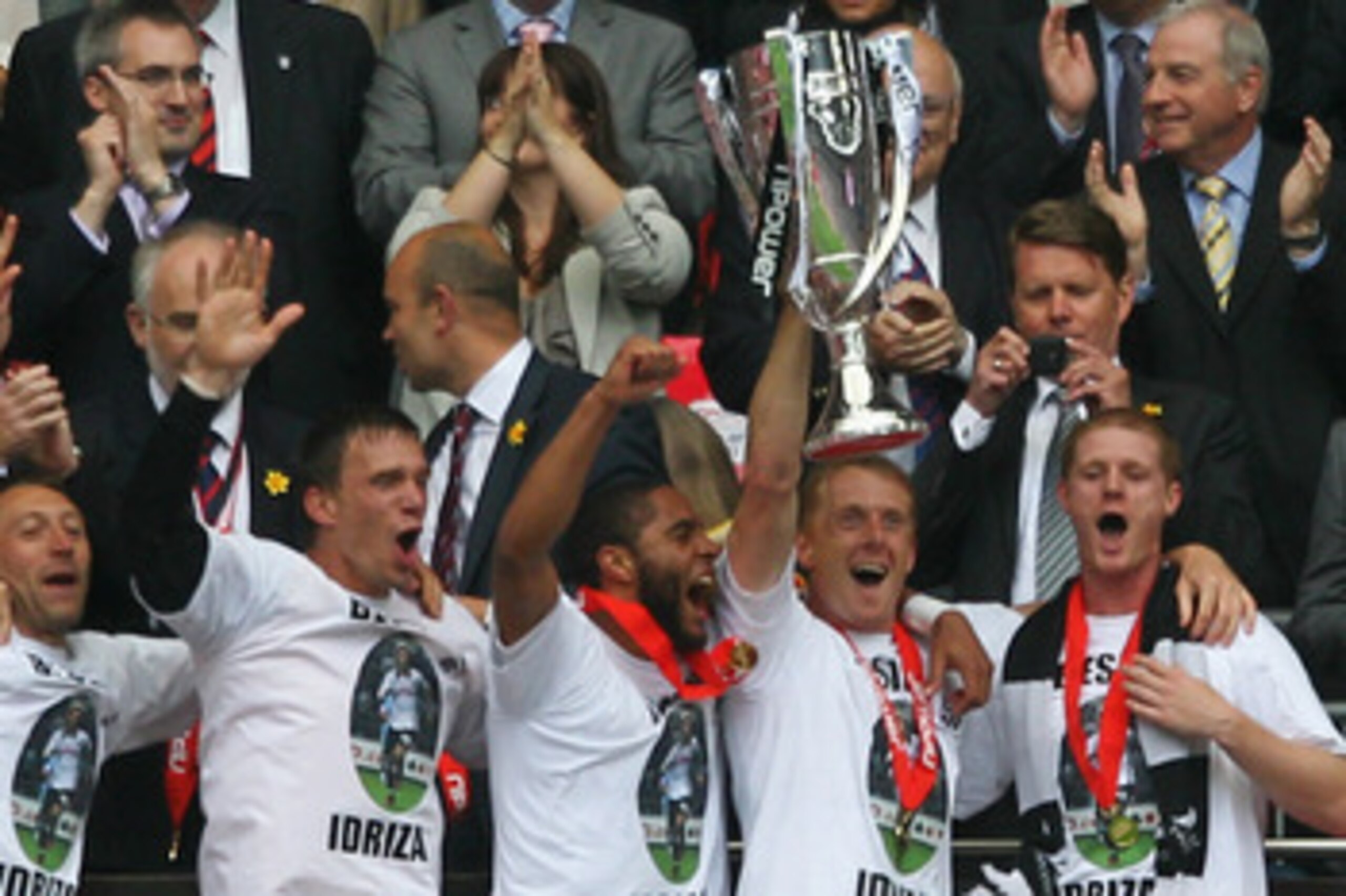 LONDON, ENGLAND - MAY 30:  Garry Monk, Captain of Swansea leads celebrations with the trophy after winning the npower Championship Playoff Final between Reading and Swansea City at Wembley Stadium on May 30, 2011 in London, England.  (Photo by Dean Mouhta