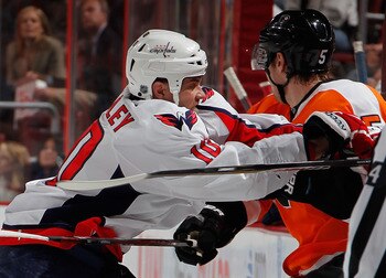 PHILADELPHIA, PA - MARCH 22:  Matt Bradley #10 of the Washington Capitals checks Braydon Coburn #5 of the Philadelphia Flyers during the first period of an NHL hockey game at the Wells Fargo Center on March 22, 2011 in Philadelphia, Pennsylvania. Capitals