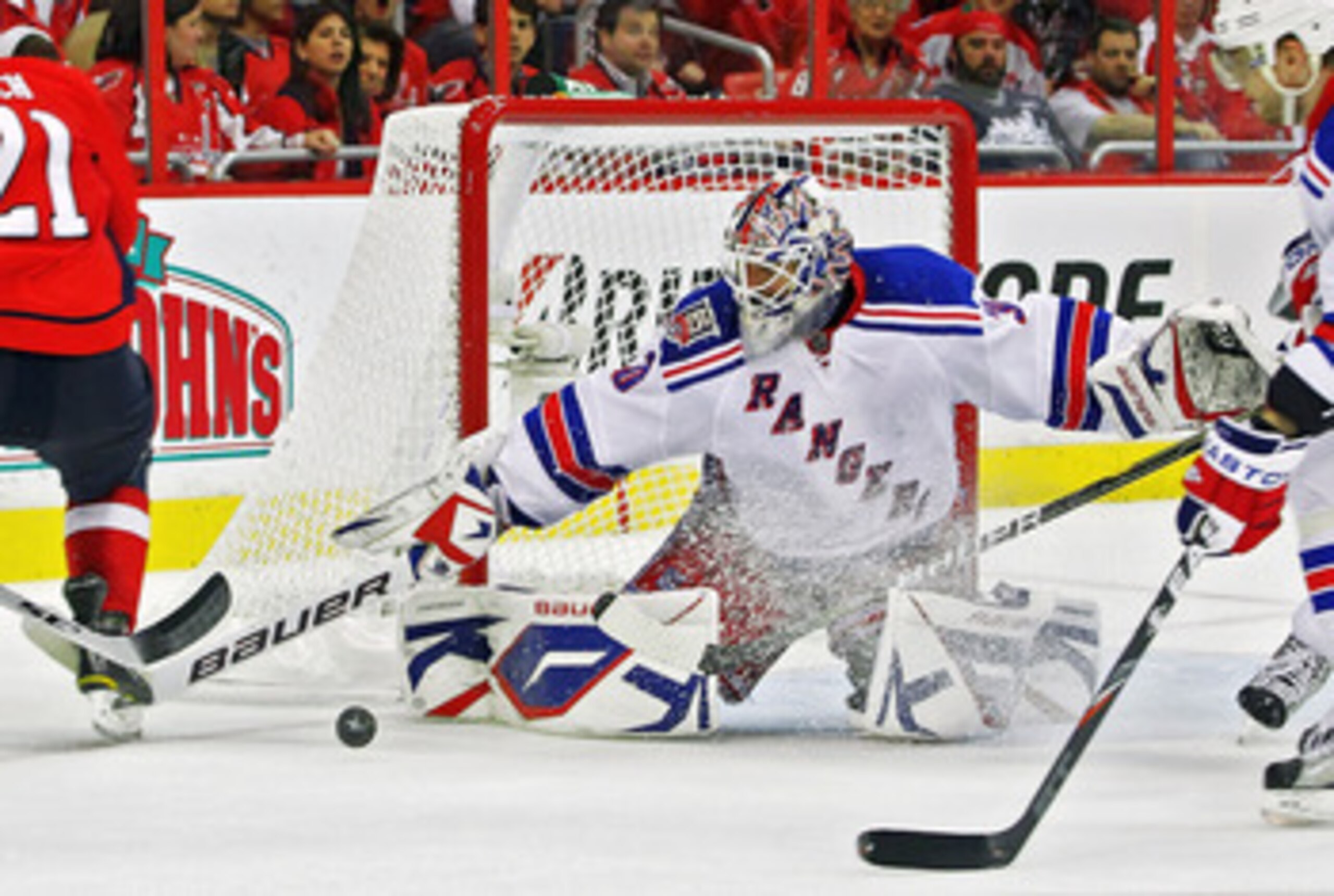 WASHINGTON , DC - APRIL 23: Henrik Lundqvist #30 of the New York Rangers stops a shot on goal by a member of the Washington Capitals in Game Five of the Eastern Conference Quarterfinals during the 2011 NHL Stanley Cup Playoffs at the Verizon Center on Ap WASHINGTON , DC - APRIL 23: Henrik Lundqvist #30 of the New York Rangers stops a shot on goal by a member of the Washington Capitals in Game Five of the Eastern Conference Quarterfinals during the 2011 NHL Stanley Cup Playoffs at the Verizon Center on Ap