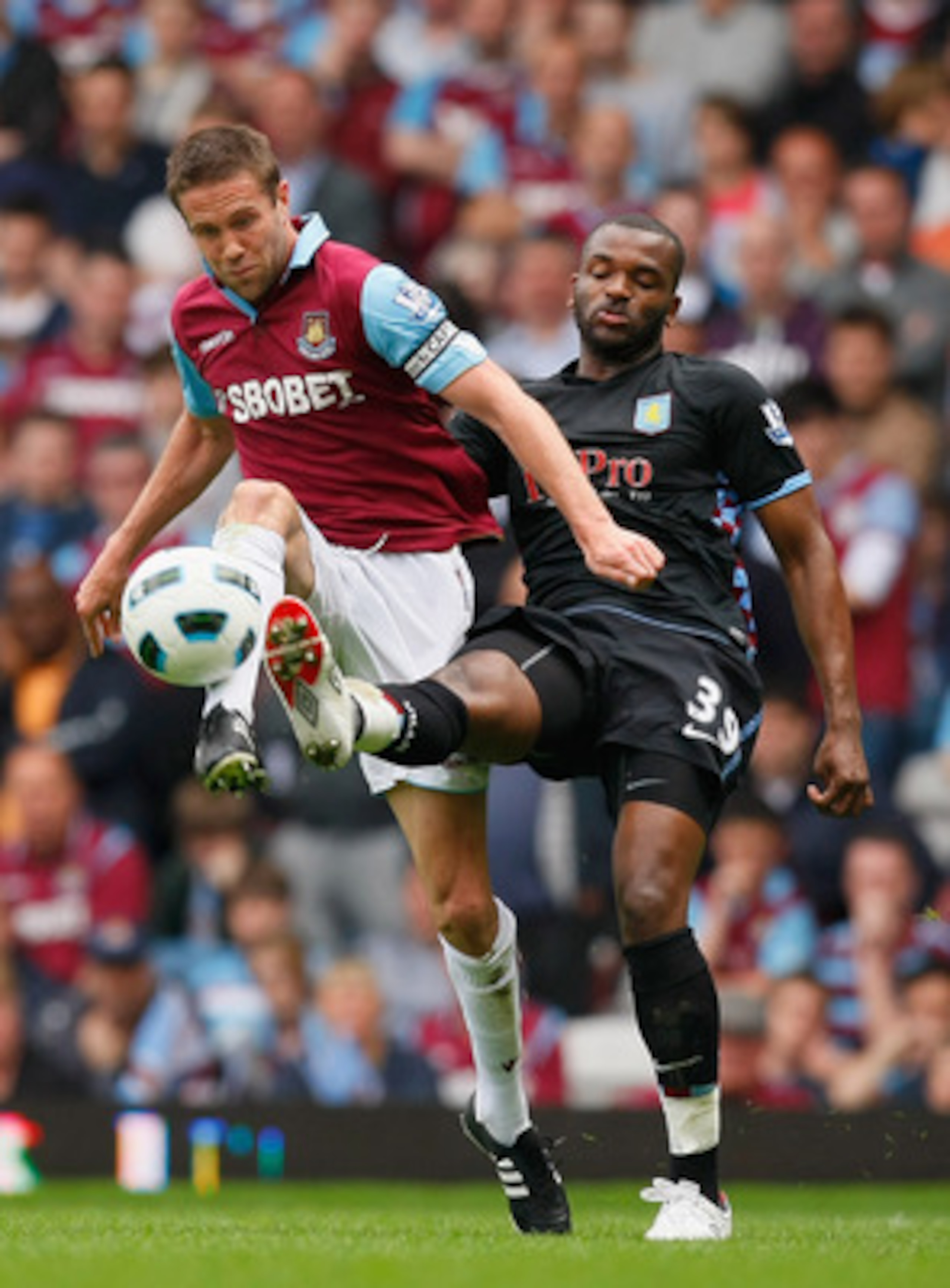 LONDON, ENGLAND - APRIL 16:  Matthew Upson of West Ham United and Darren Bent of Aston Villa battle for the ball during the Barclays Premier League match between West Ham United and Aston Villa at the Boleyn Ground on April 16, 2011 in London, England.  (