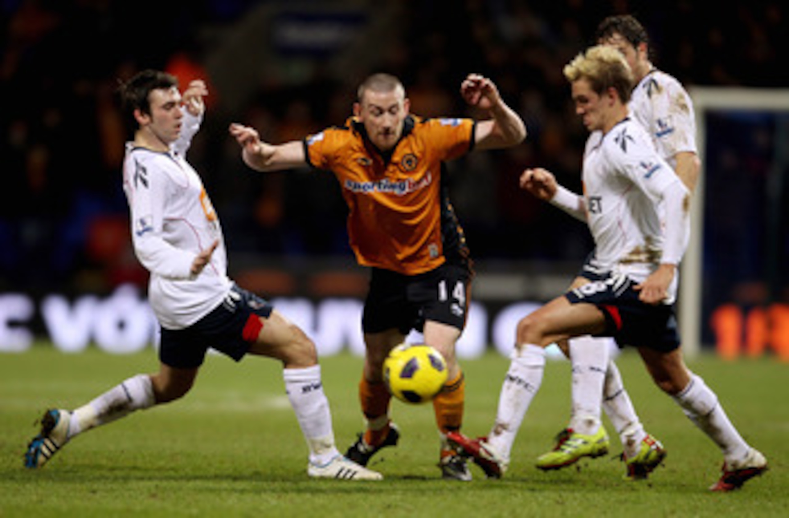 BOLTON, ENGLAND - FEBRUARY 01: David Jones of Wolves (C) in action with Mark Davies (L) and Stuart Holden (R) of Bolton during the Barclays Premier League match between Bolton Wanderers and Wolverhampton Wanderers at Reebok Stadium on February 2, 2011 in 