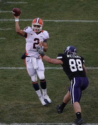 CHICAGO - NOVEMBER 20: Nathan Scheelhaase #2 of the Illinois Fighting Illini passes the ball under pressure from Quentin Williams #88 of the Northwestern Wildcats during a game played at Wrigley Field on November 20, 2010 in Chicago, Illinois. (Photo by J