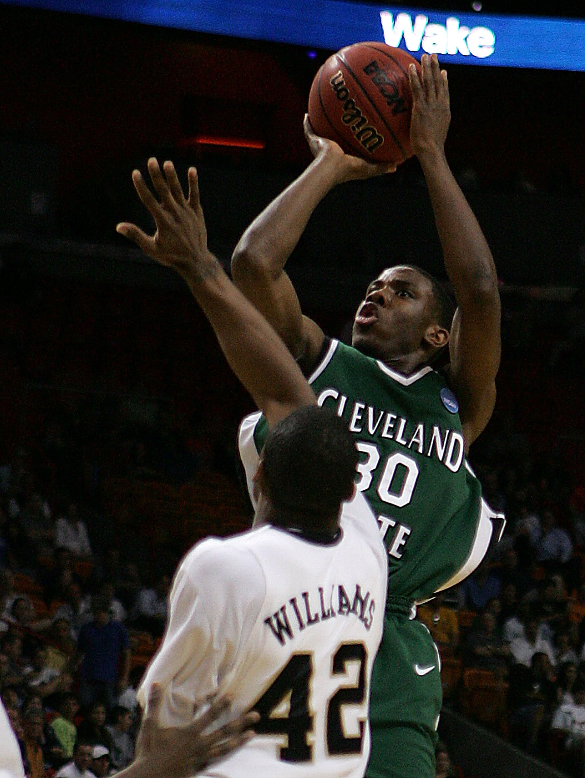MIAMI - MARCH 20:  Guard Norris Cole #30 (R) of the Cleveland State University Vikings takes a shot over  guard L.D. Williams #42 (L) of Wake Forest Demon Deacons during the first round of the NCAA Division I Men's Basketball Tournament at the American Ai
