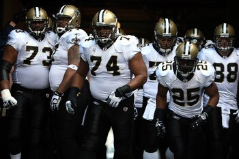 SEATTLE, WA - JANUARY 08:  Jahri Evans #73, Jermon Bushrod #74 and Reggie Bush #25 of the New Orleans Saints wait in the tunnel before running out on the field to take on the Seattle Seahawks in the 2011 NFC wild-card playoff game at Qwest Field on Januar
