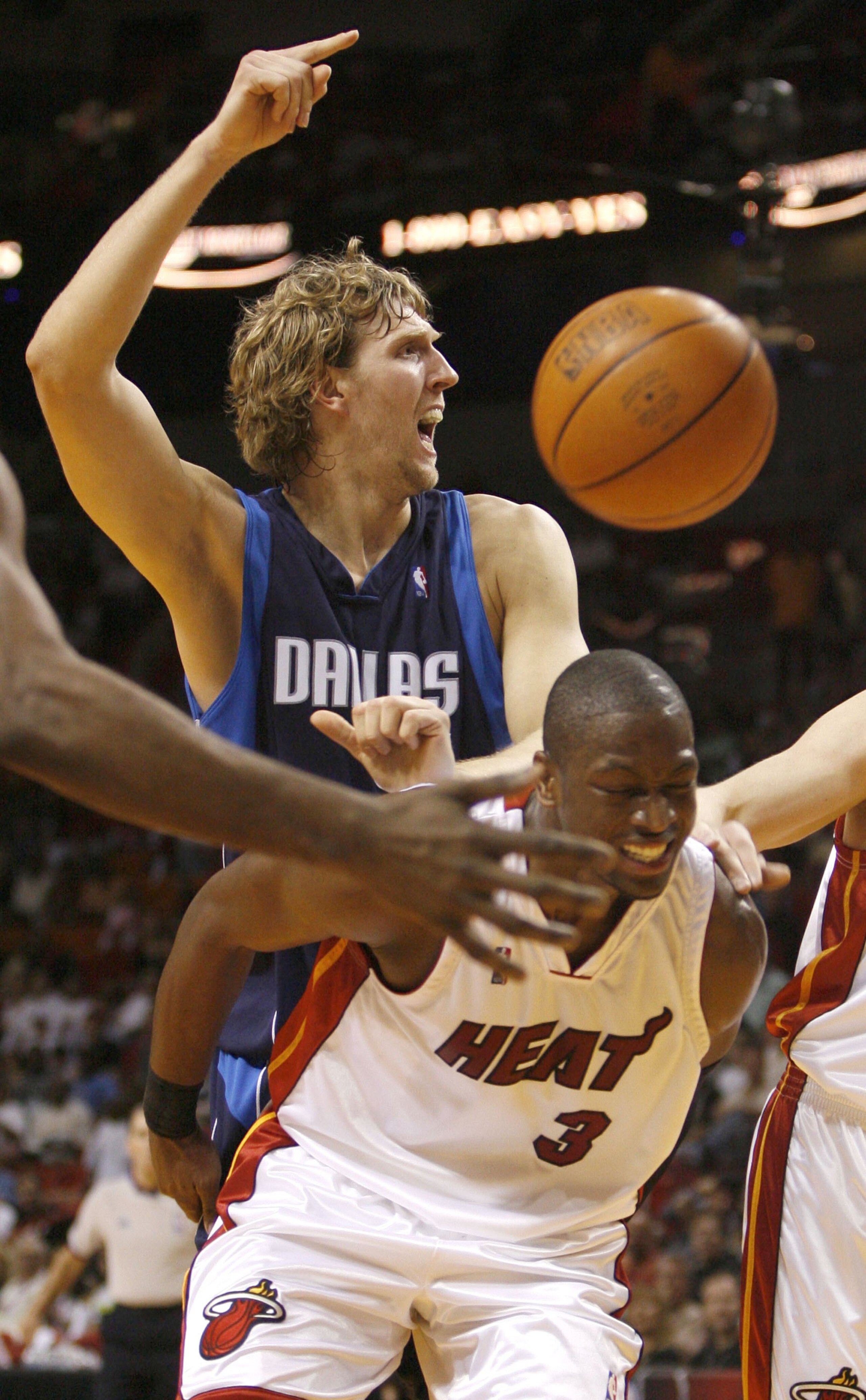 MIAMI - JANUARY 21:  Guard Dwyane Wade #3 of the Miami Heat cringes in pain while spraining is left ankle against Dirk Nowitzki #41of the Dallas Mavericks on January 21, 2007 at the American Airlines Arena in Miami  Florida.  NOTE TO USER: User expressly