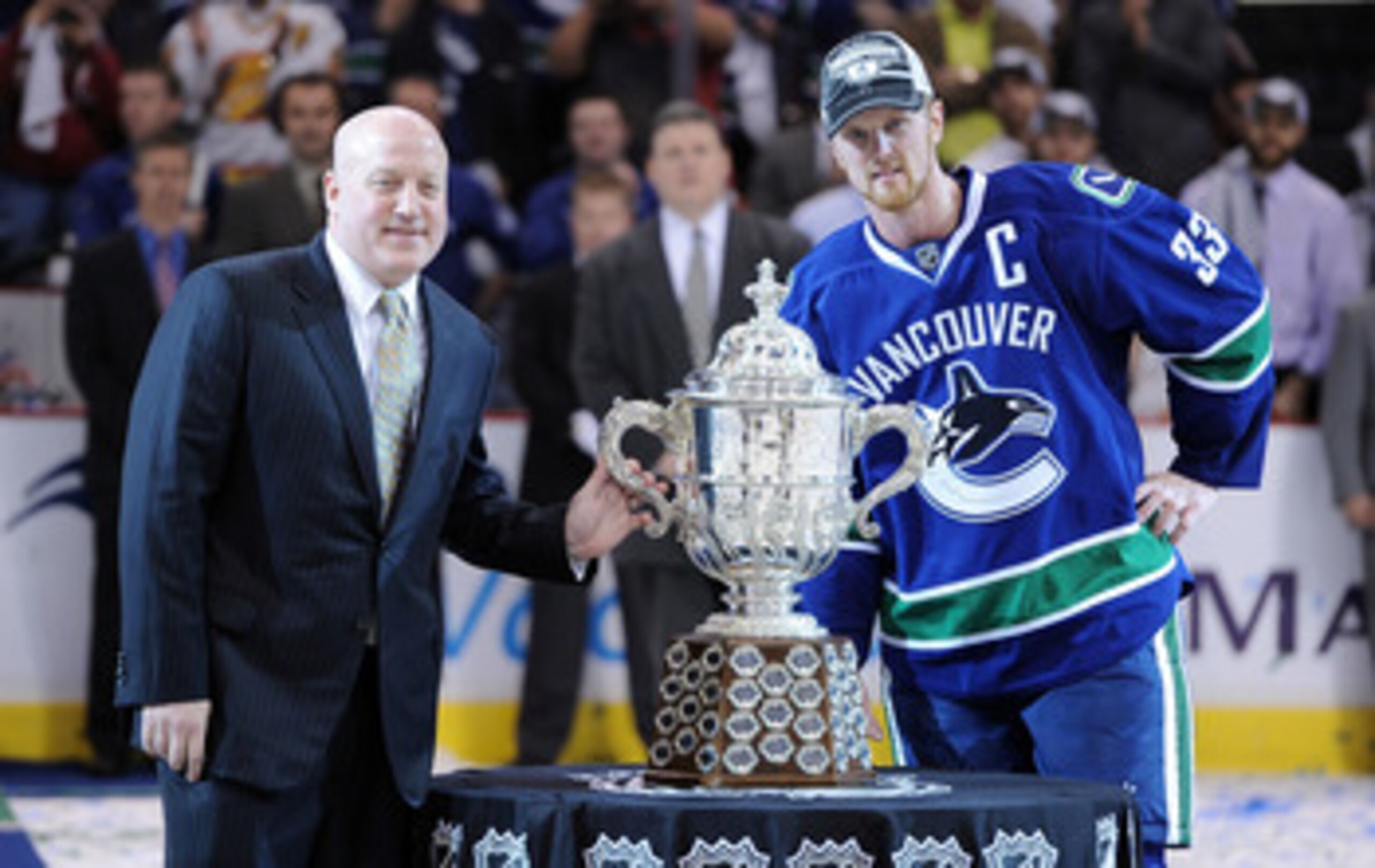 VANCOUVER, BC - MAY 24:  NHL Deputy Commissioner Bill Daly and Captain Henrik Sedin #33 of the Vancouver Canucks pose with the Clarence Campbell Bowl after the Vancouver Canucks defeated the San Jose Sharks 3-2 in double-overtime in Game Five to win the W