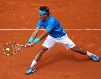 PARIS, FRANCE - MAY 30:  Rafael Nadal of Spain plays a backhand during the men's singles round four match between Rafael Nadal of Spain and Ivan Lubicic of Croatia on day nine of the French Open at Roland Garros on May 30, 2011 in Paris, France.  (Photo b