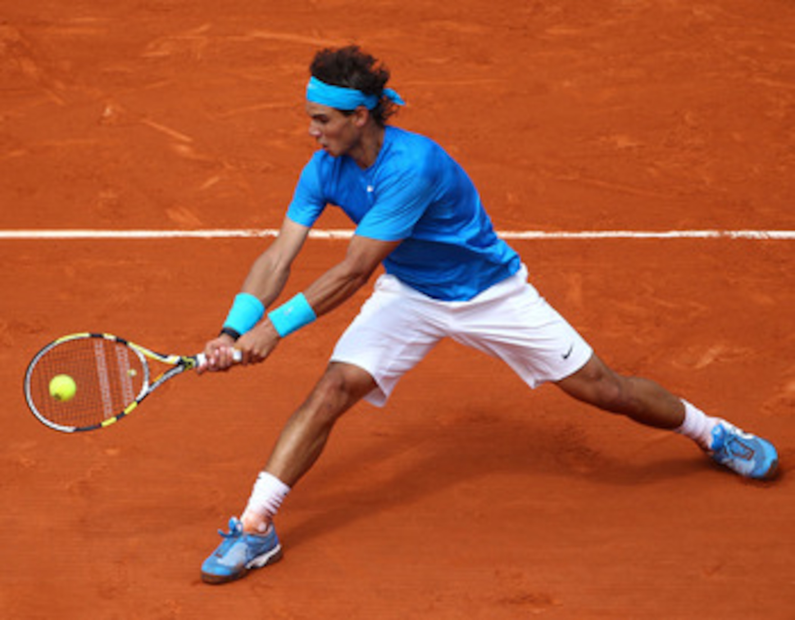 PARIS, FRANCE - MAY 30:  Rafael Nadal of Spain plays a backhand during the men's singles round four match between Rafael Nadal of Spain and Ivan Lubicic of Croatia on day nine of the French Open at Roland Garros on May 30, 2011 in Paris, France.  (Photo b