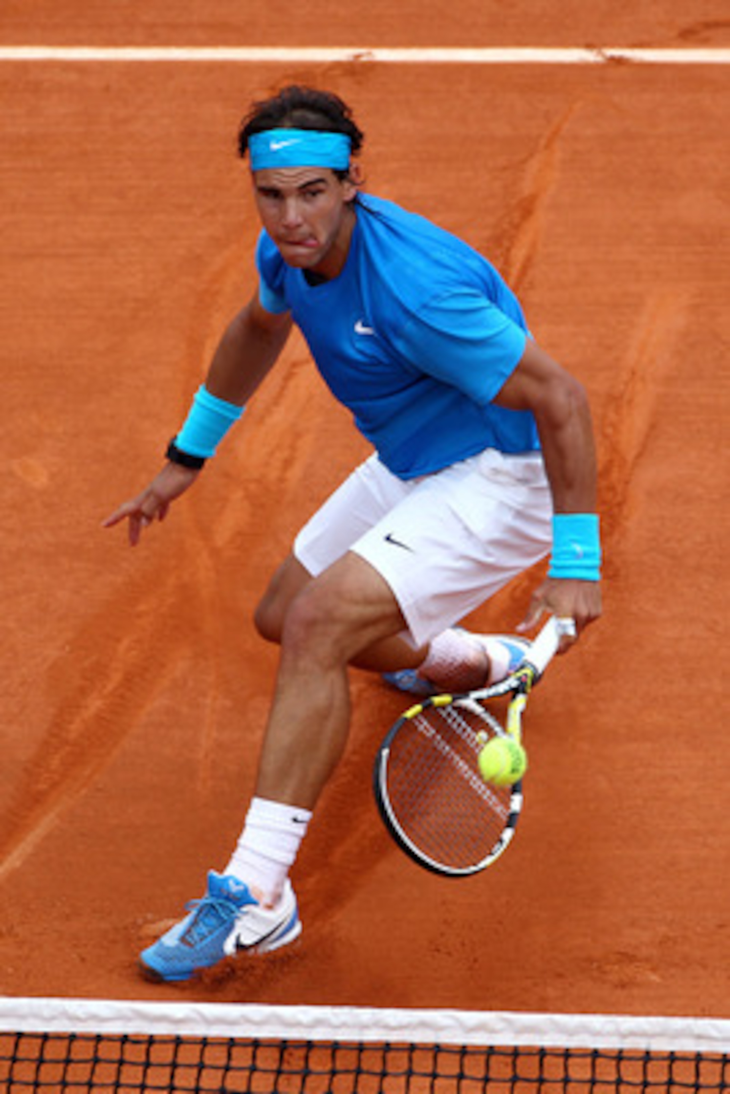 PARIS, FRANCE - MAY 30:  Rafael Nadal of Spain volleys during the men's singles round four match between Rafael Nadal of Spain and Ivan Lubicic of Croatia on day nine of the French Open at Roland Garros on May 30, 2011 in Paris, France.  (Photo by Clive B