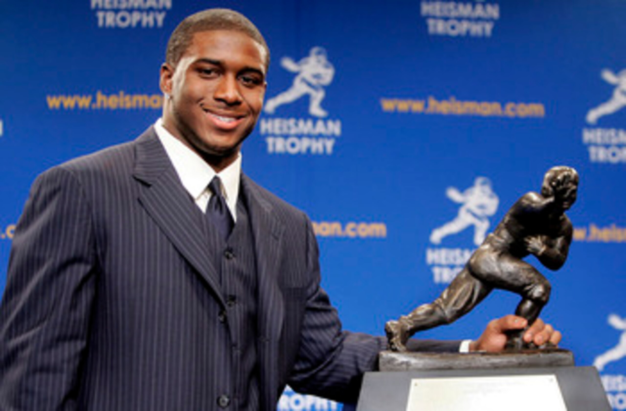 NEW YORK - DECEMBER 10:  Running back Reggie Bush #5 of the USC Trojans poses with the 2005 Heisman trophy after winning the award at the 71st Annual Heisman Ceremony on December 10, 2005 in New York City.  (Photo by Stephen Chernin/Getty Images)
