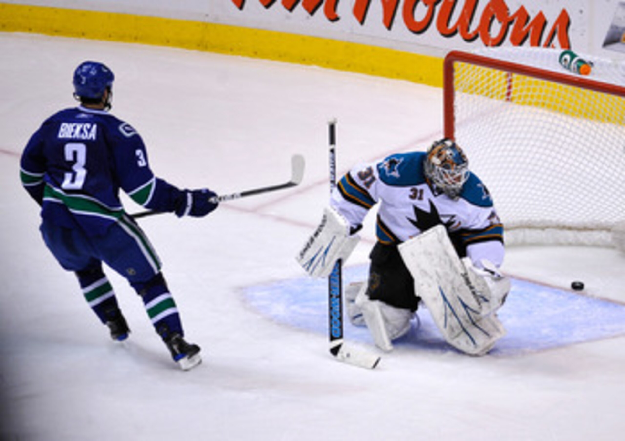 VANCOUVER, CANADA - MAY 18:  Kevin Bieksa #3 of the Vancouver Canucks scores against Antti Niemi #31 of the San Jose Sharks in the second period in Game Two of the Western Conference Finals during the 2011 Stanley Cup Playoffs at Rogers Arena on May 18, 2