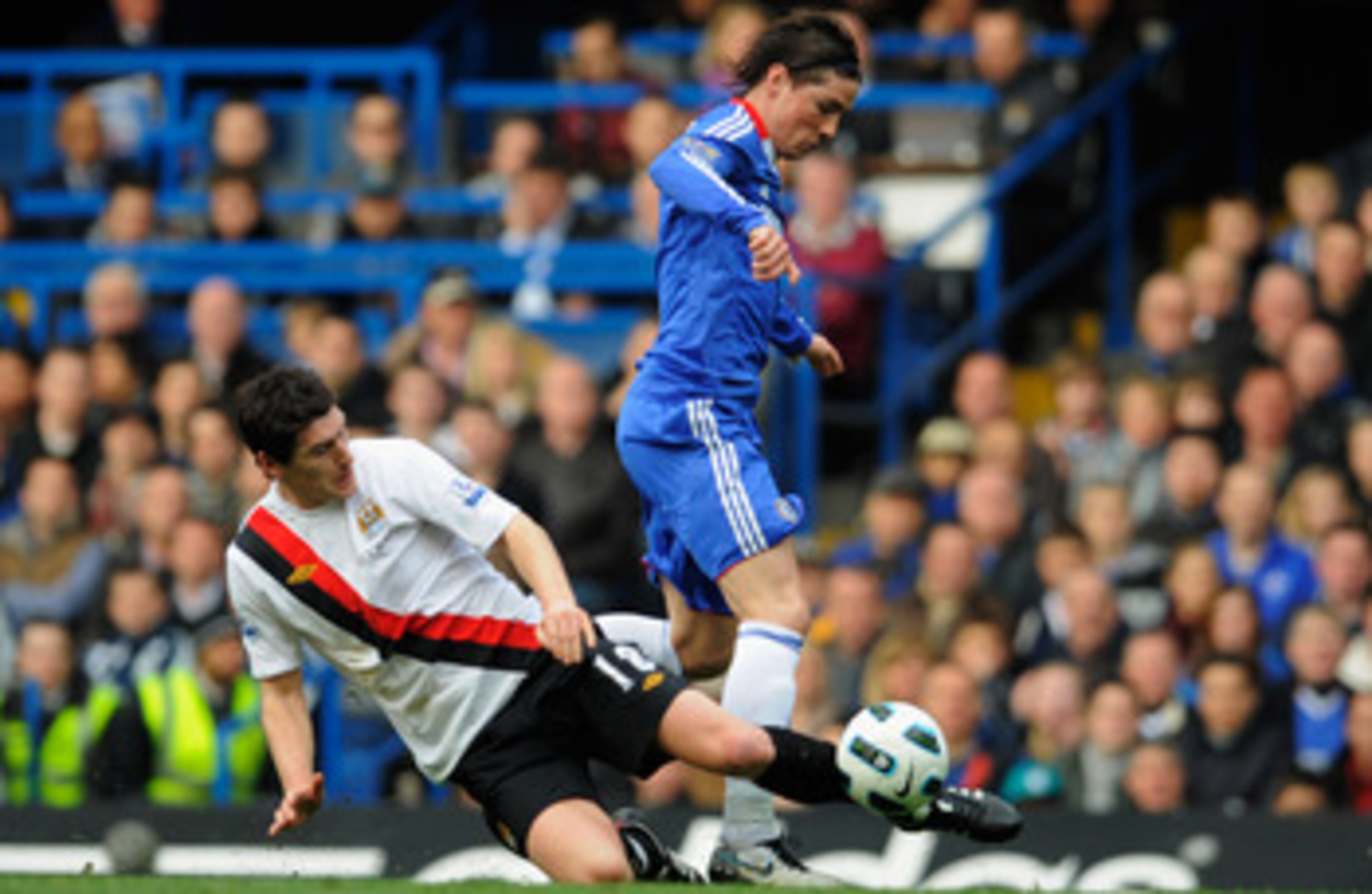 LONDON, ENGLAND - MARCH 20:  Fernando Torres of Chelsea is tackled by Gareth Barry of Manchester City during the Barclays Premier League match between Chelsea and Manchester City at Stamford Bridge on March 20, 2011 in London, England.  (Photo by Michael