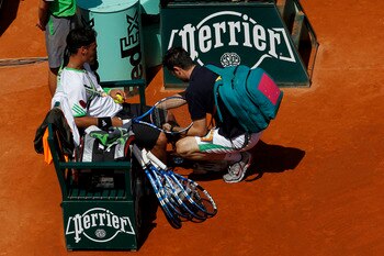 PARIS, FRANCE - MAY 29:  Fabio Fognini of Italy receives treatment from ATP physiotherapist Hugo Gravil during the men's singles round four match between Fabio Fognini of Italy and Albert Montanes of Spain on day eight of the French Open at Roland Garros 
