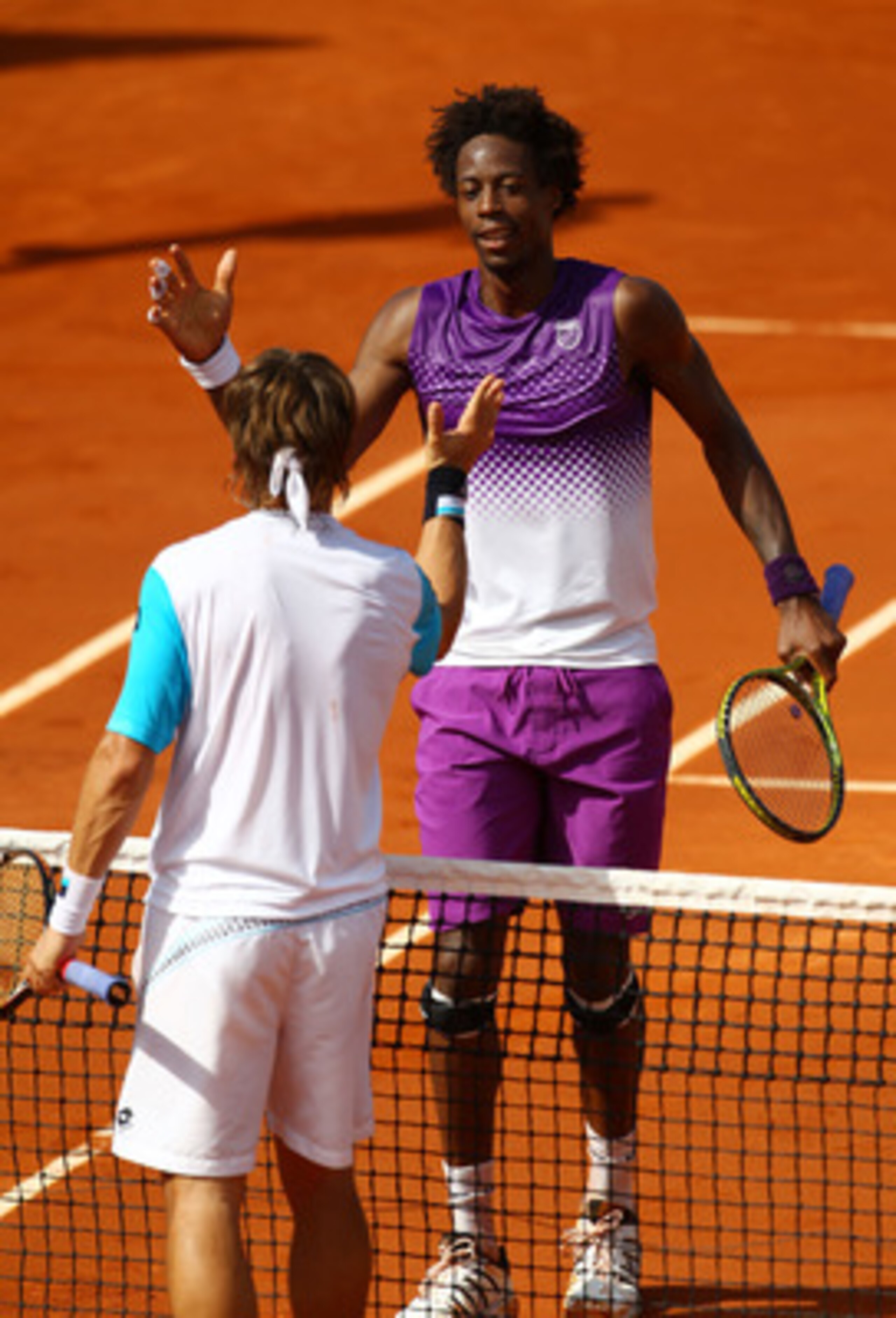 PARIS, FRANCE - MAY 30:  Gael Monfils of France shakes hands with David Ferrer of Spain following his victory during the men's singles round four match between David Ferrer of Spain and Gael Monfils of France on day nine of the French Open at Roland Garro
