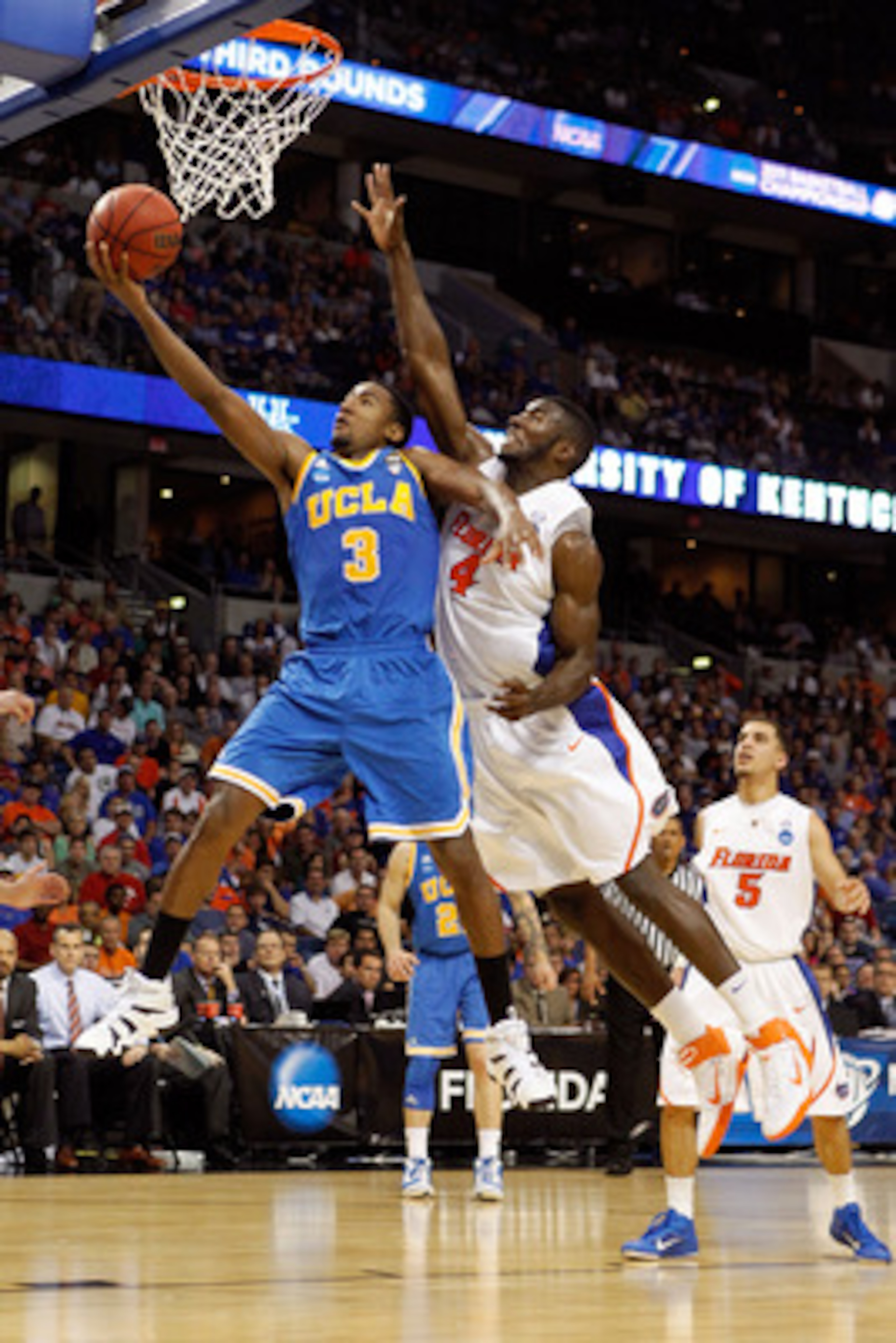 TAMPA, FL - MARCH 19:  Malcolm Lee #3 of the UCLA Bruins drives for a shot attempt against Patric Young #4 of the Florida Gators during the third round of the 2011 NCAA men's basketball tournament at St. Pete Times Forum on March 19, 2011 in Tampa, Florid