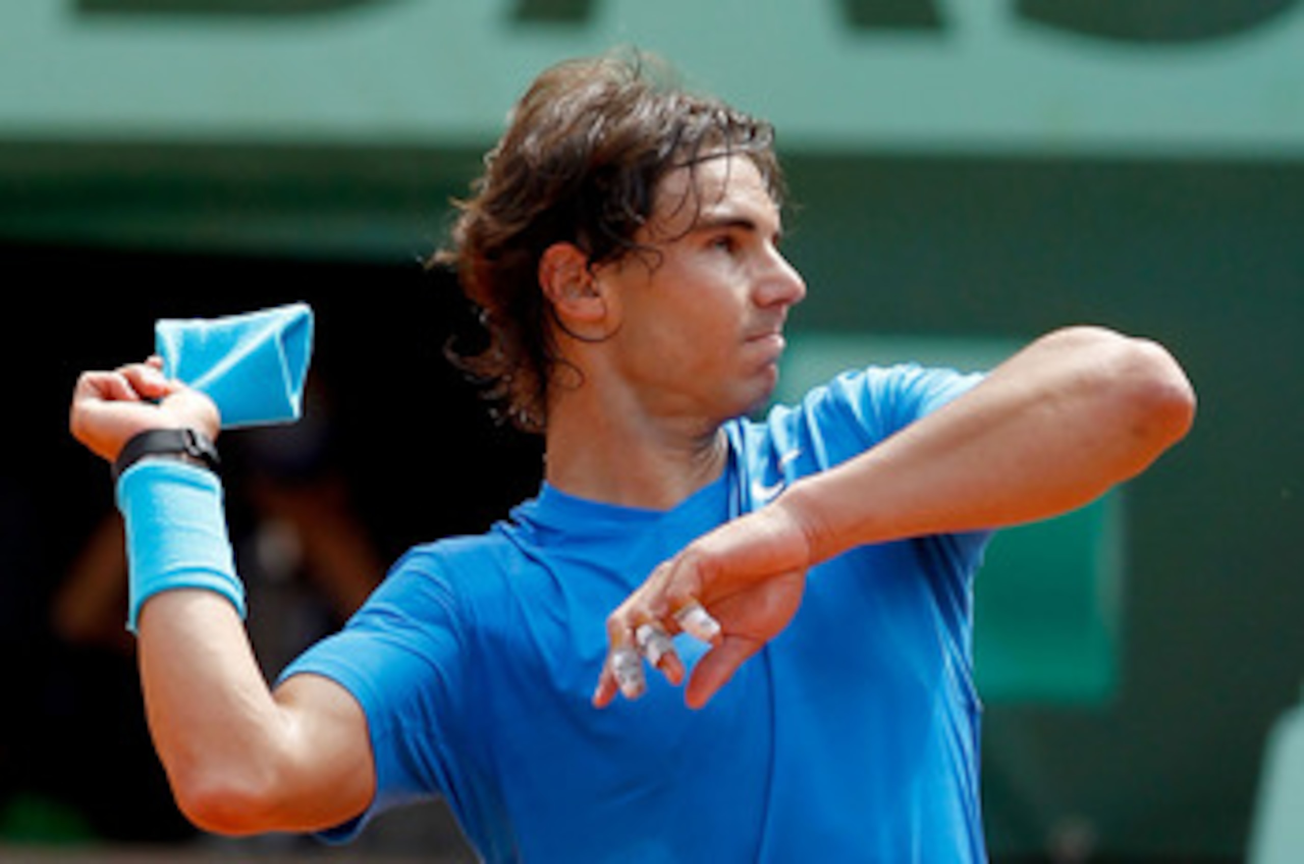 PARIS, FRANCE - MAY 30:  Rafael Nadal of Spain throws his sweatband into the crowd following his victory during the men's singles round four match between Rafael Nadal of Spain and Ivan Lubicic of Croatia on day nine of the French Open at Roland Garros on