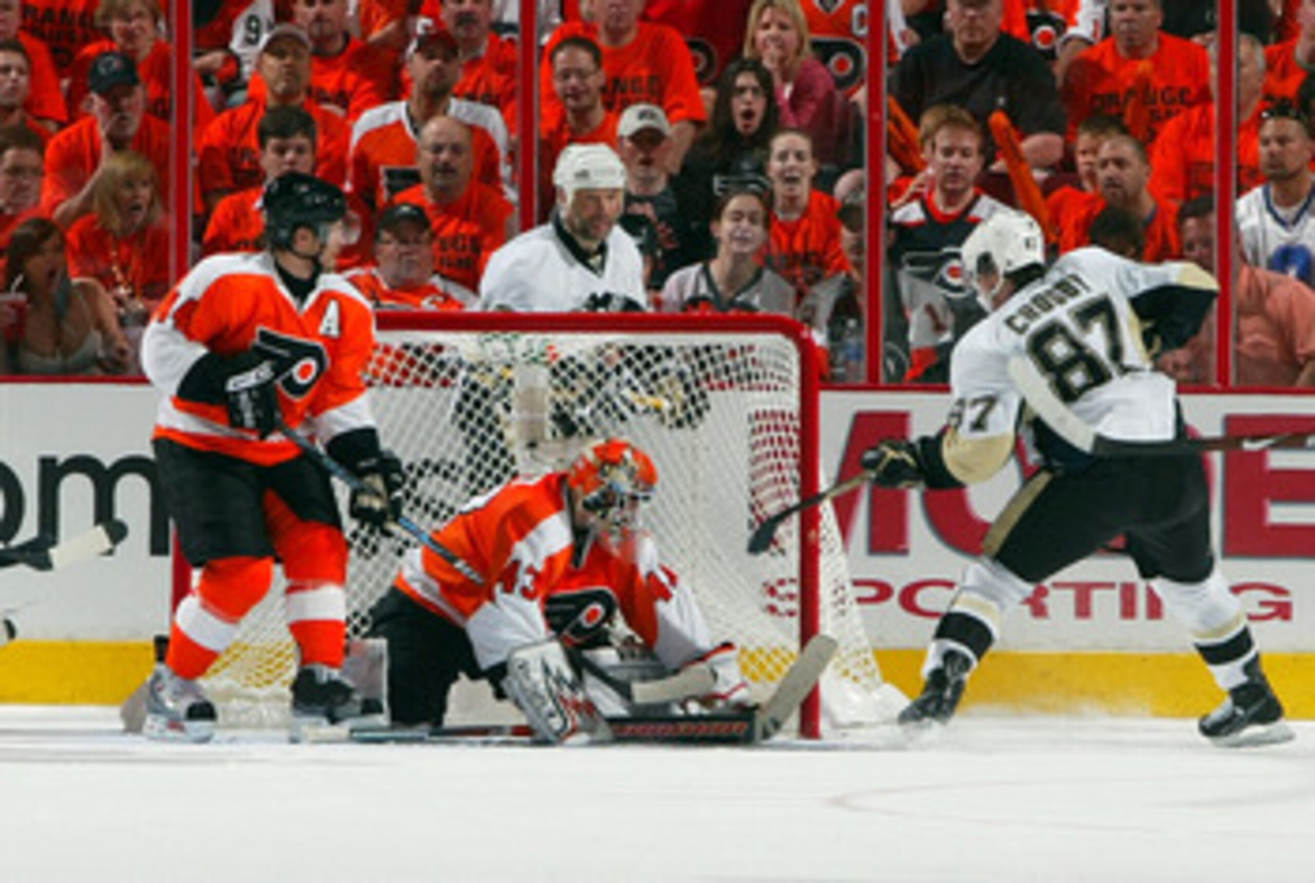 PHILADELPHIA - APRIL 25:  Sidney Crosby #87 of the Pittsburgh Penguin taps the puck past Martin Biron #43 of the Philadelphia Flyers to tie the game at three in the second period during Game Six of the Eastern Conference Quarterfinal Round of the 2009 NHL
