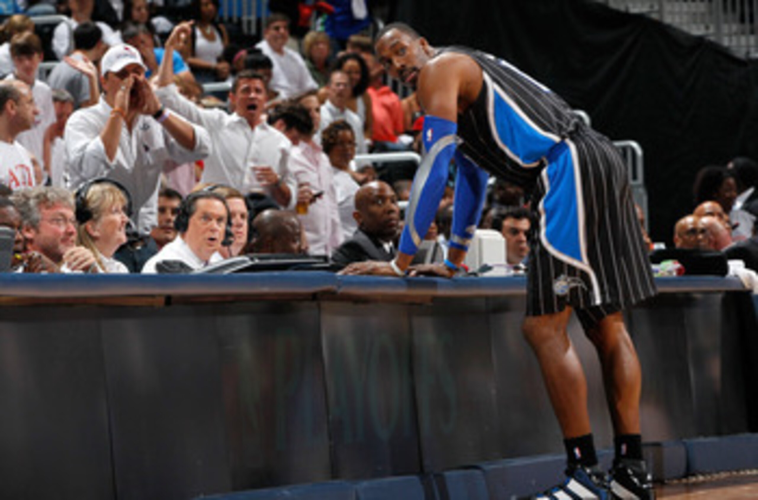 ATLANTA, GA - APRIL 28:  Dwight Howard #12 of the Orlando Magic stands at the scorer's table after being earning a technical foul against Zaza Pachulia #27 of the Atlanta Hawks during Game Six of the Eastern Conference Quarterfinals in the 2011 NBA Playof