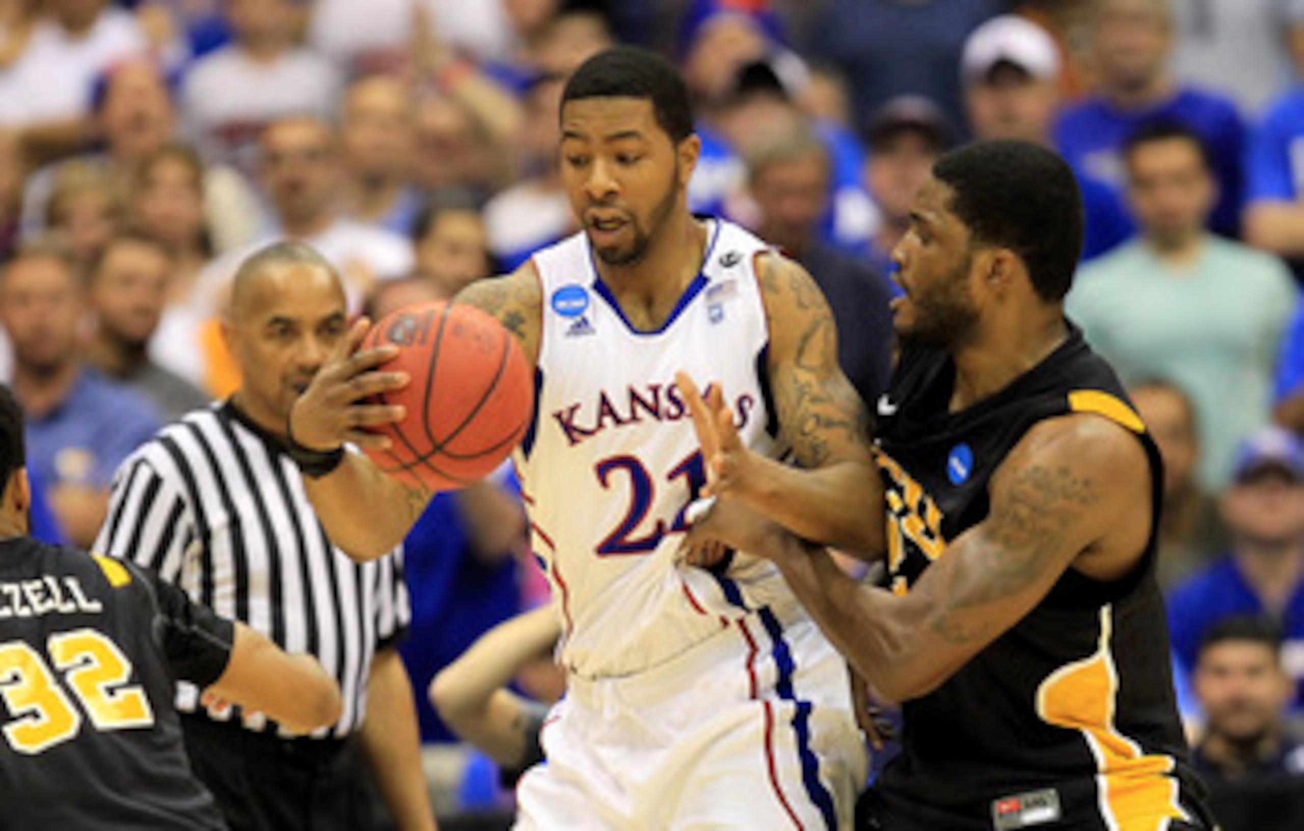 SAN ANTONIO, TX - MARCH 27:  Markieff Morris #21 of the Kansas Jayhawks handles the ball against Jamie Skeen #21 of the Virginia Commonwealth Rams during the southwest regional final of the 2011 NCAA men's basketball tournament at the Alamodome on March 2