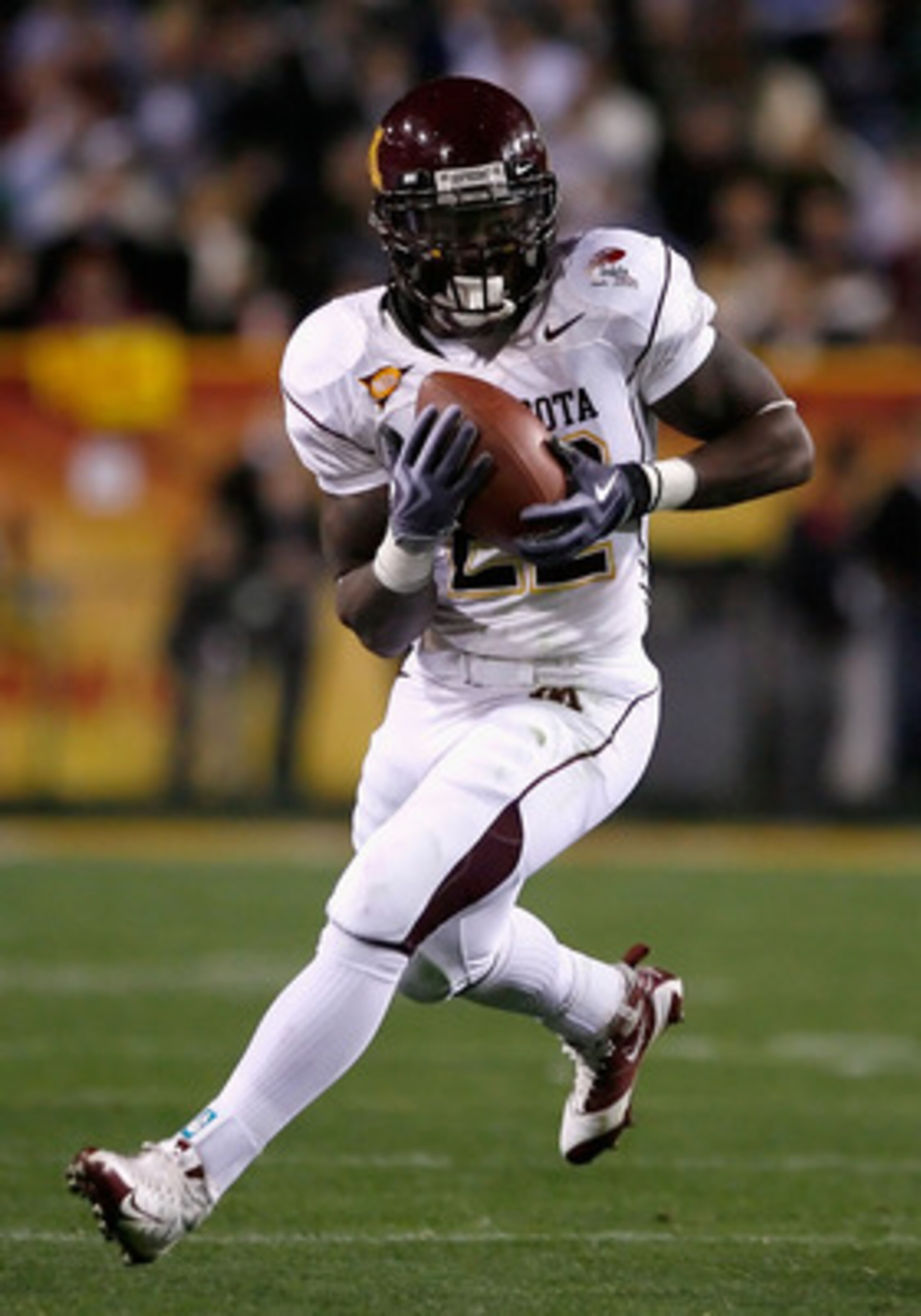 TEMPE, AZ - DECEMBER 31: Runningback Duane Bennett #22 of the Minnesota Golden Gophers rushes the football against the Iowa State Cyclones during the Insight Bowl at Arizona Stadium on December 31, 2009 in Tempe, Arizona. The Cyclones defeated the Golden TEMPE, AZ - DECEMBER 31: Runningback Duane Bennett #22 of the Minnesota Golden Gophers rushes the football against the Iowa State Cyclones during the Insight Bowl at Arizona Stadium on December 31, 2009 in Tempe, Arizona. The Cyclones defeated the Golden