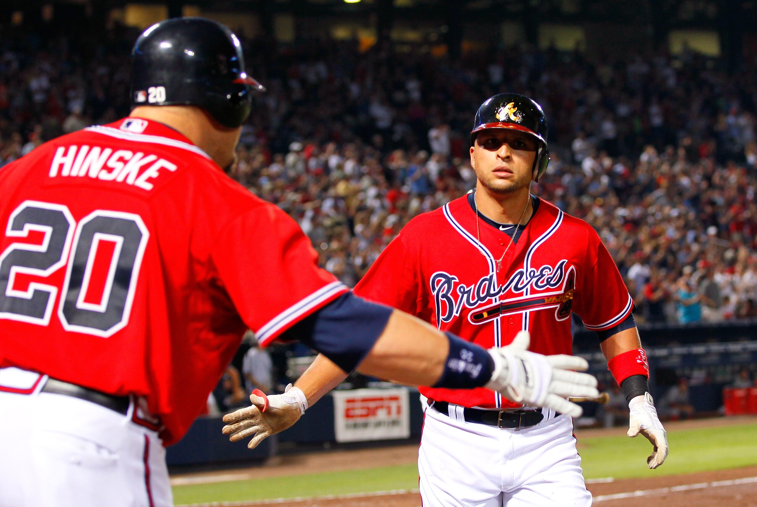 ATLANTA, GA - MAY 29:  Martin Prado #14 of the Atlanta Braves celebrates with Eric Hinske #20 after a two-run homer in the sixth inning against the Cincinnati Reds at Turner Field on May 29, 2011 in Atlanta, Georgia.  (Photo by Kevin C. Cox/Getty Images)