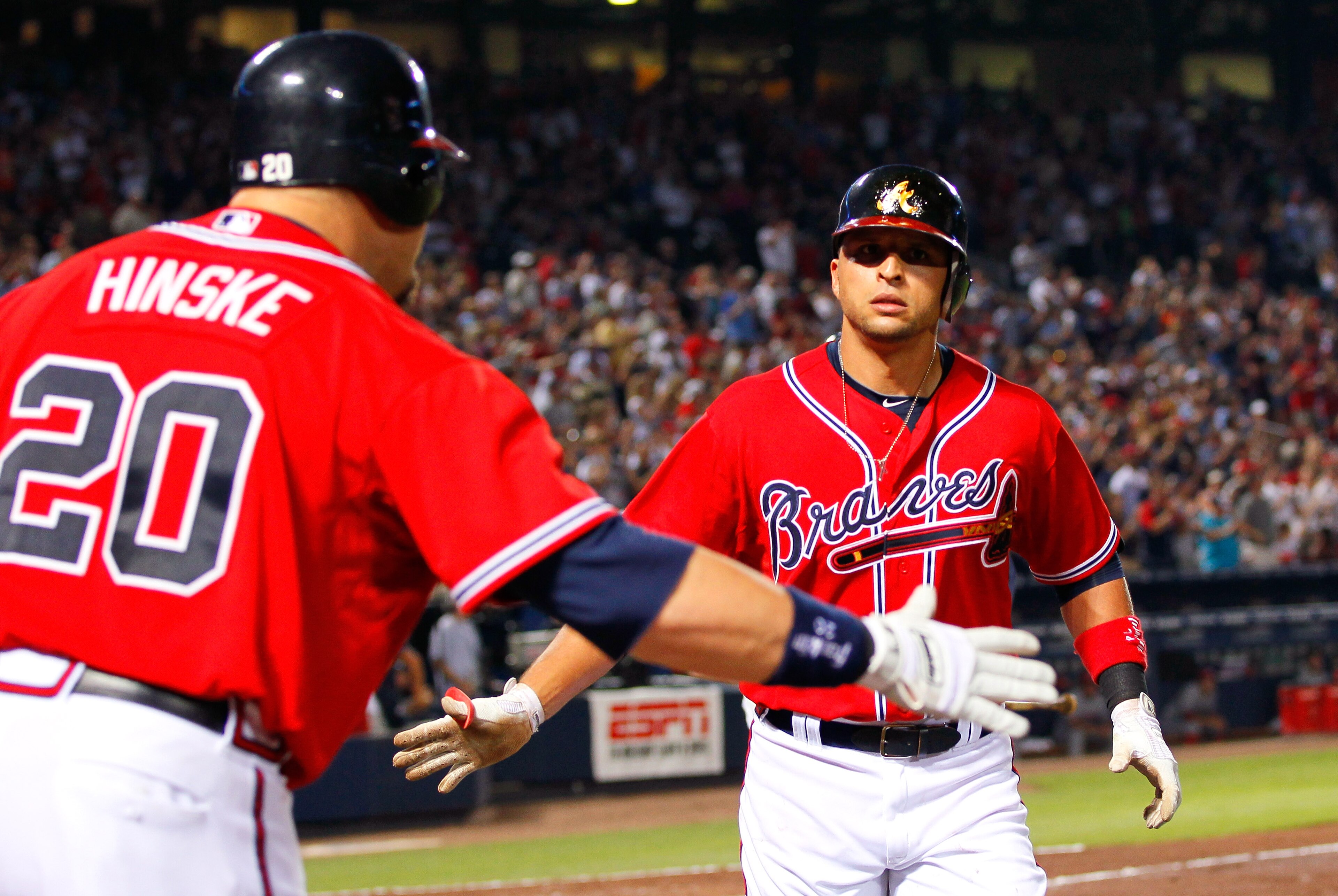 ATLANTA, GA - MAY 29:  Martin Prado #14 of the Atlanta Braves celebrates with Eric Hinske #20 after a two-run homer in the sixth inning against the Cincinnati Reds at Turner Field on May 29, 2011 in Atlanta, Georgia.  (Photo by Kevin C. Cox/Getty Images)
