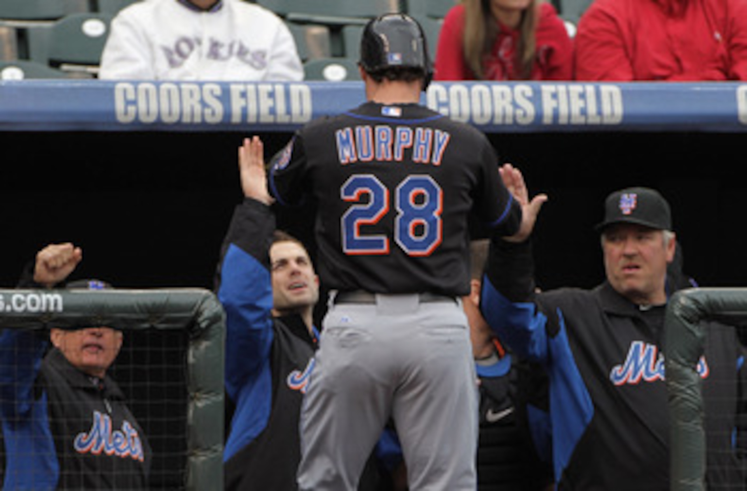DENVER, CO - MAY 12:  Daniel Murphy #28 of the New York Mets is welcomed back to the dugout after scoring on a two RBI single by Jose Reyes #7 of the Mets to give the Mets a 5-1 lead over the Colorado Rockies in the fourth inning at Coors Field on May 12,