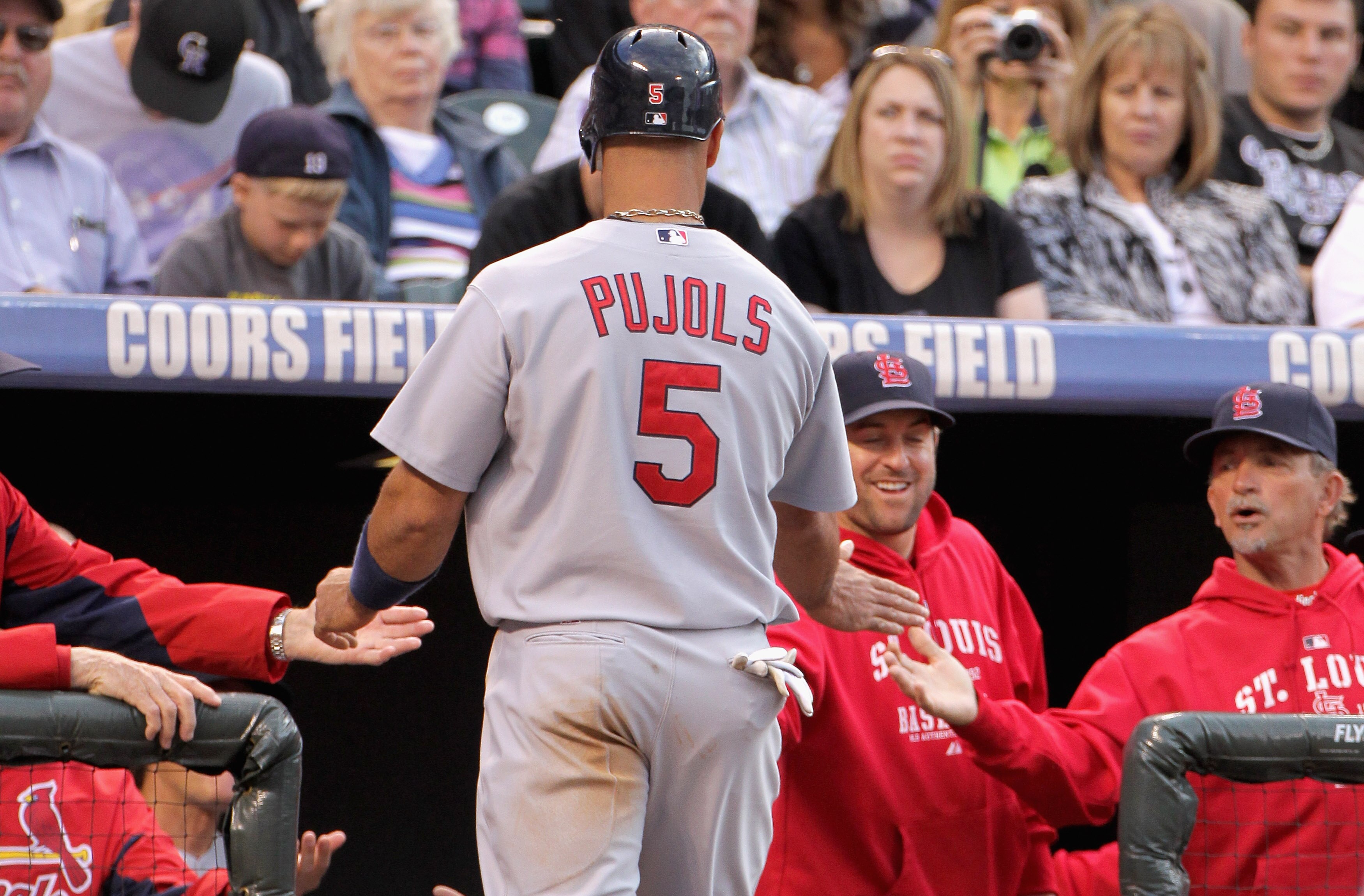 DENVER, CO - MAY 27:  Albert Pujols #5 of the St. Louis Cardinals is welcomed back to the dugout after scoring against the Colorado Rockies in the third inning at Coors Field on May 27, 2011 in Denver, Colorado.  (Photo by Doug Pensinger/Getty Images)