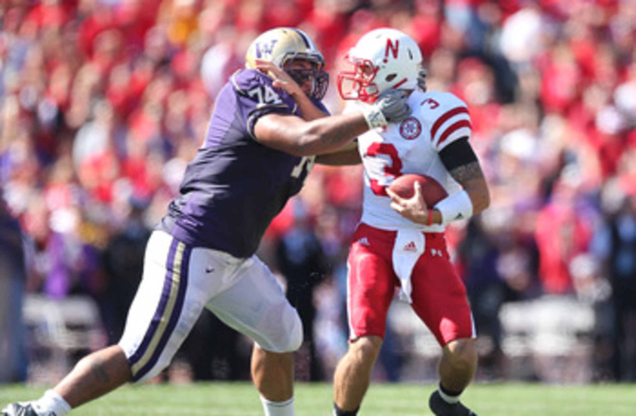SEATTLE - SEPTEMBER 18: Quarterback Taylor Martinez #3 of the Nebraska Cornhuskers is tackled by Alameda Ta'amu #74 of the Washington Huskies on September 18, 2010 at Husky Stadium in Seattle, Washington. (Photo by Otto Greule Jr/Getty Images)