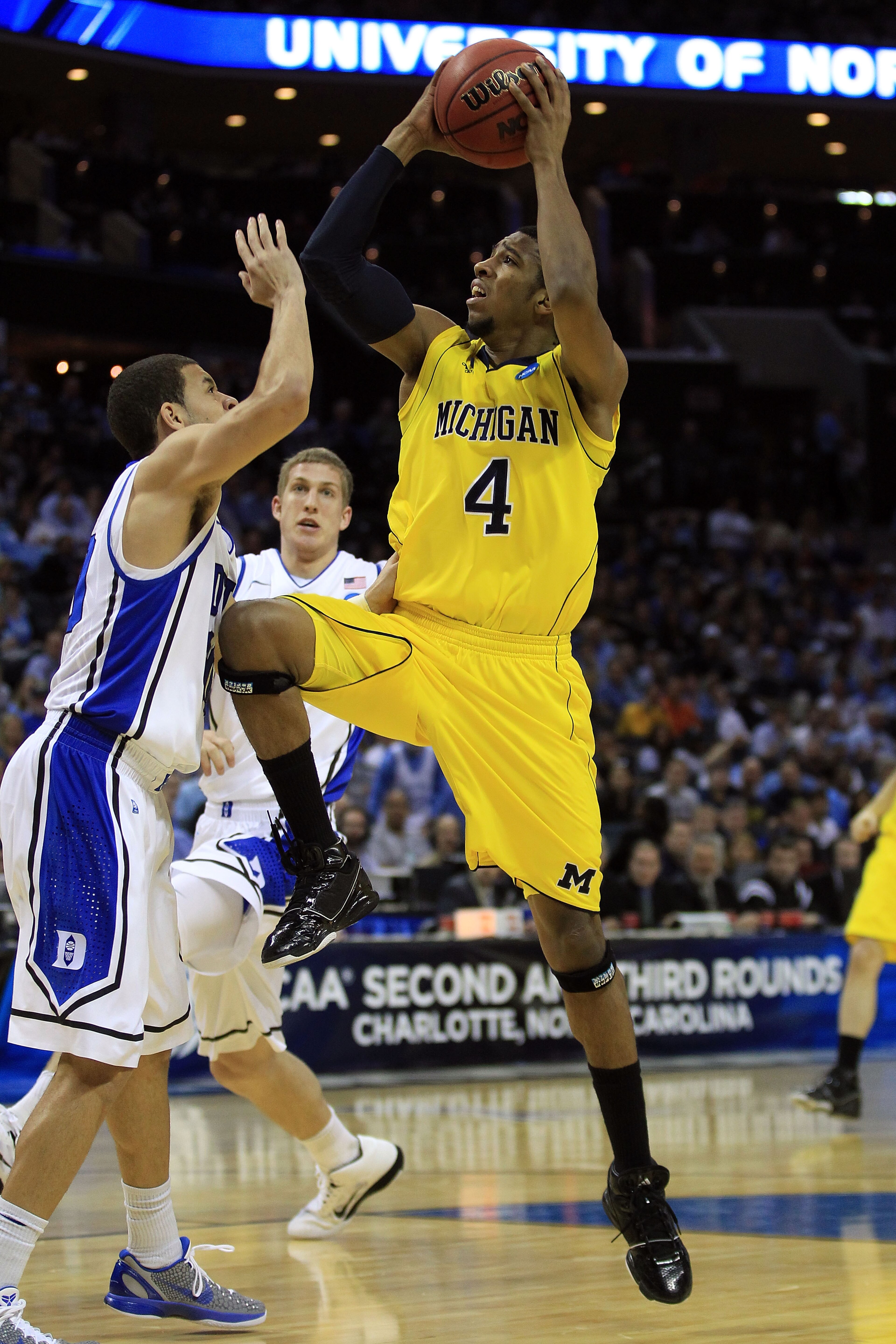 CHARLOTTE, NC - MARCH 20: Darius Morris #4 of the Michigan Wolverines goes up for a shot against Seth Curry #30 of the Duke Blue Devils during the third round of the 2011 NCAA men's basketball tournament at Time Warner Cable Arena on March 20, 2011 in Ch CHARLOTTE, NC - MARCH 20: Darius Morris #4 of the Michigan Wolverines goes up for a shot against Seth Curry #30 of the Duke Blue Devils during the third round of the 2011 NCAA men's basketball tournament at Time Warner Cable Arena on March 20, 2011 in Ch