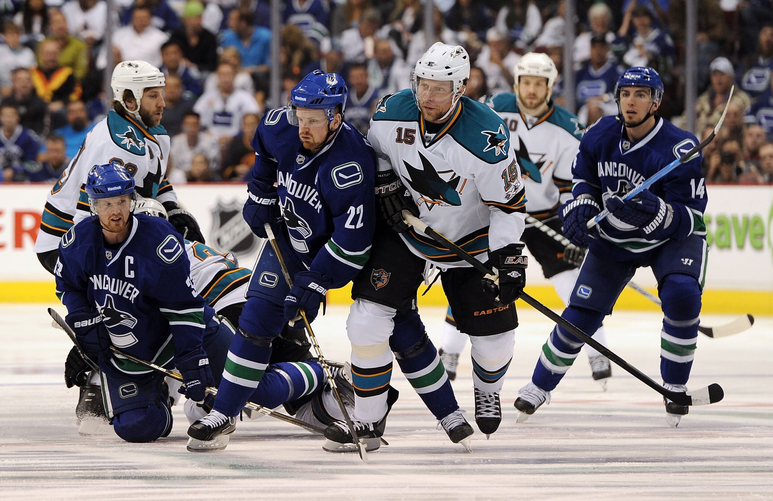 VANCOUVER, CANADA - MAY 18:  Daniel Sedin #22 of the Vancouver Canucks and Dany Heatley #15 of the San Jose Sharks vie for position as Alex Burrows #14 and Henrik Sedin #33 of the Vancouver Canucks look on in Game Two of the Western Conference Finals duri