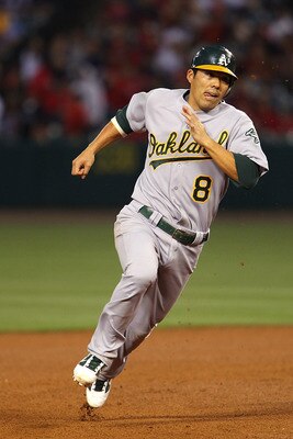 ANAHEIM, CA - MAY 24:  Kurt Suzuki #8 of the Oakland Athletics rounds second base and goes all the way to score from a fly ball hit by David DeJesus #12 in the fourth inning during the game against the Los Angeles Angels of Anaheim at Angel Stadium on May