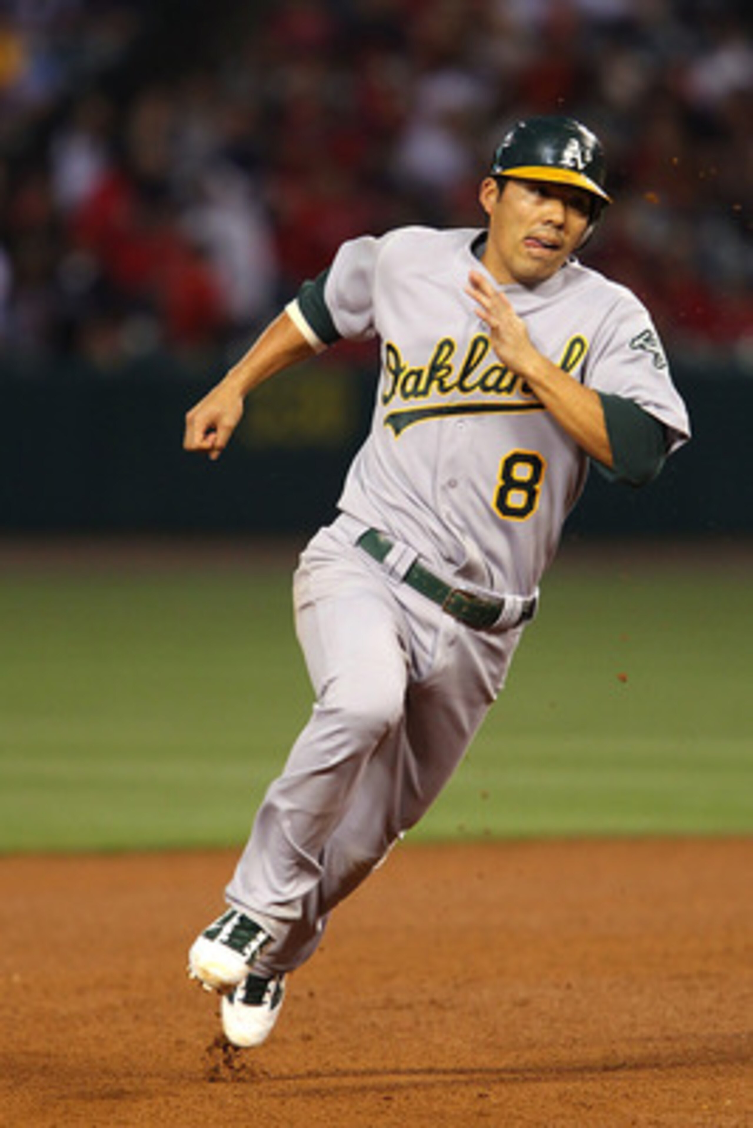 ANAHEIM, CA - MAY 24: Kurt Suzuki #8 of the Oakland Athletics rounds second base and goes all the way to score from a fly ball hit by David DeJesus #12 in the fourth inning during the game against the Los Angeles Angels of Anaheim at Angel Stadium on May ANAHEIM, CA - MAY 24: Kurt Suzuki #8 of the Oakland Athletics rounds second base and goes all the way to score from a fly ball hit by David DeJesus #12 in the fourth inning during the game against the Los Angeles Angels of Anaheim at Angel Stadium on May