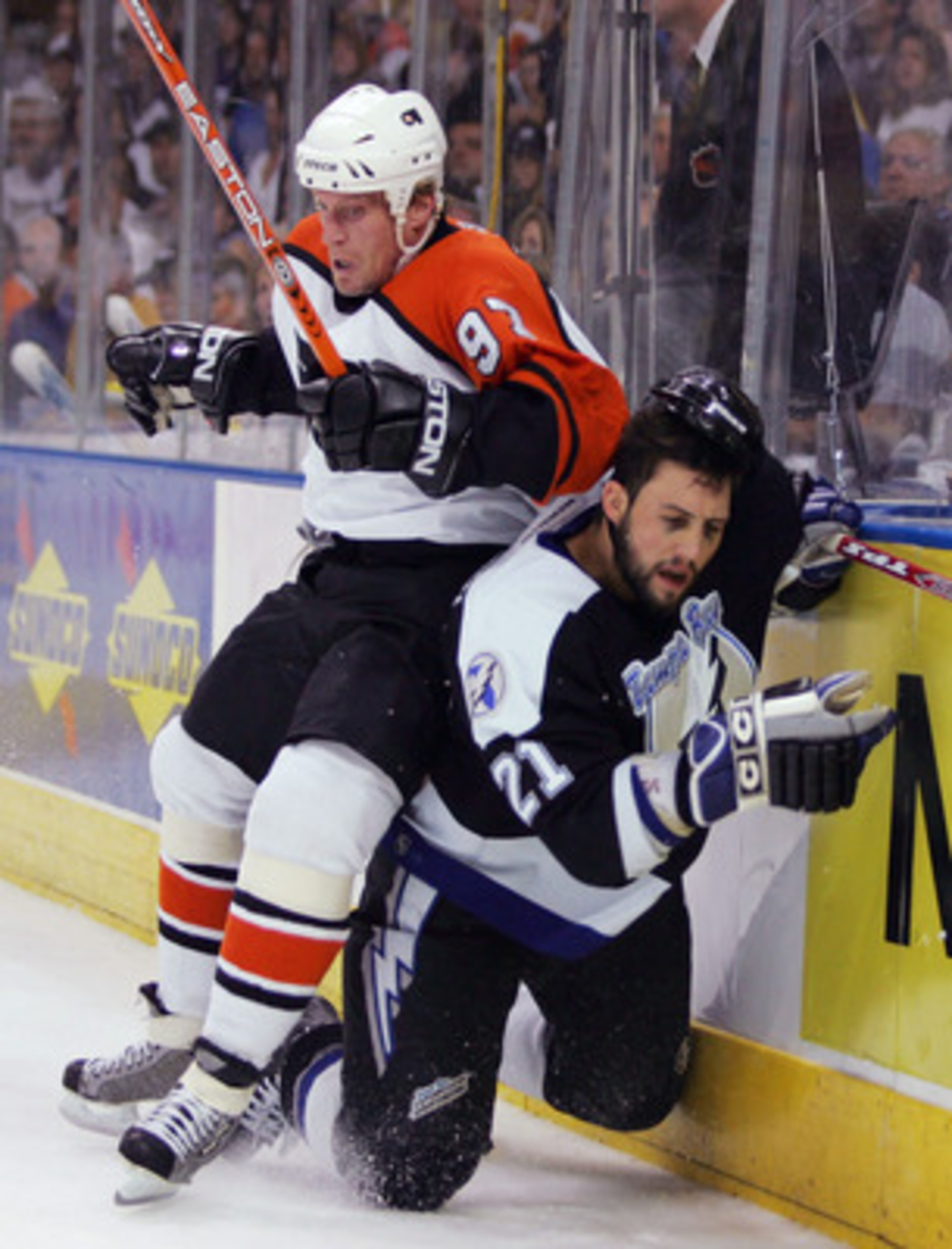 TAMPA, FL - MAY 18: Jeremy Roenick #97 of the Philadelphia Flyers checks Cory Sarich #21 of the Tampa Bay Lightning into the boards in game five of the NHL Eastern Conference Finals during the Stanley Cup Playoffs on May 18, 2004 at the St. Pete Times Fo TAMPA, FL - MAY 18: Jeremy Roenick #97 of the Philadelphia Flyers checks Cory Sarich #21 of the Tampa Bay Lightning into the boards in game five of the NHL Eastern Conference Finals during the Stanley Cup Playoffs on May 18, 2004 at the St. Pete Times Fo
