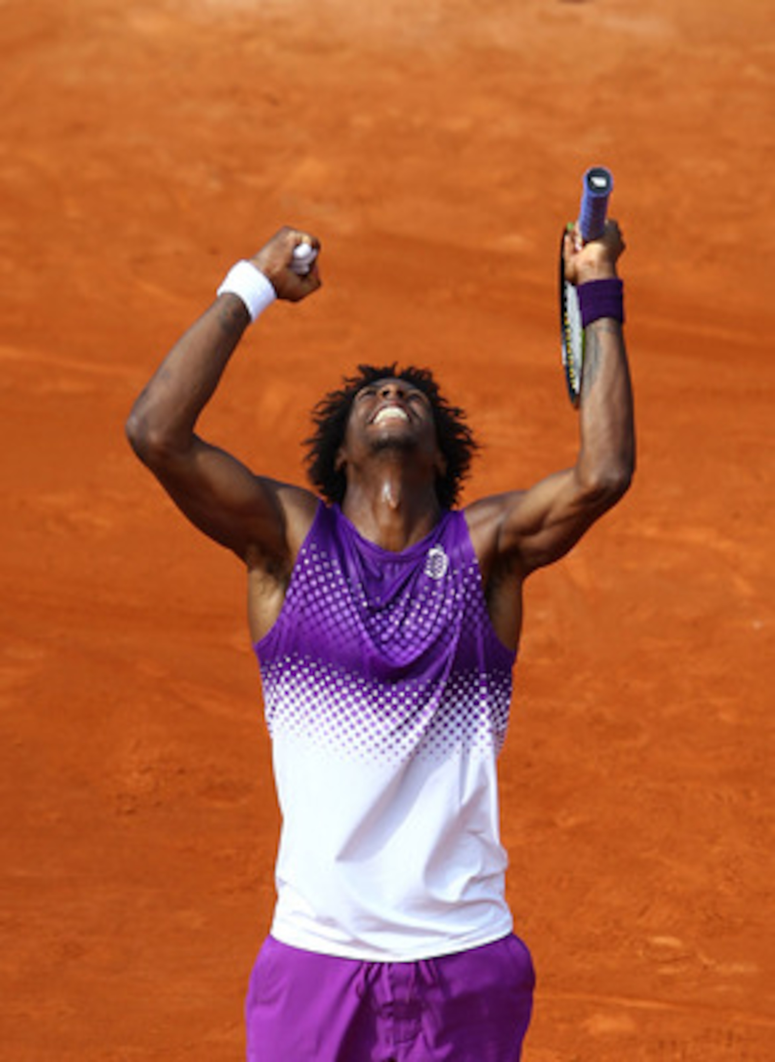 PARIS, FRANCE - MAY 30:  Gael Monfils of France celebrates matchpoint during the men's singles round four match between David Ferrer of Spain and Gael Monfils of France on day nine of the French Open at Roland Garros on May 30, 2011 in Paris, France.  (Ph