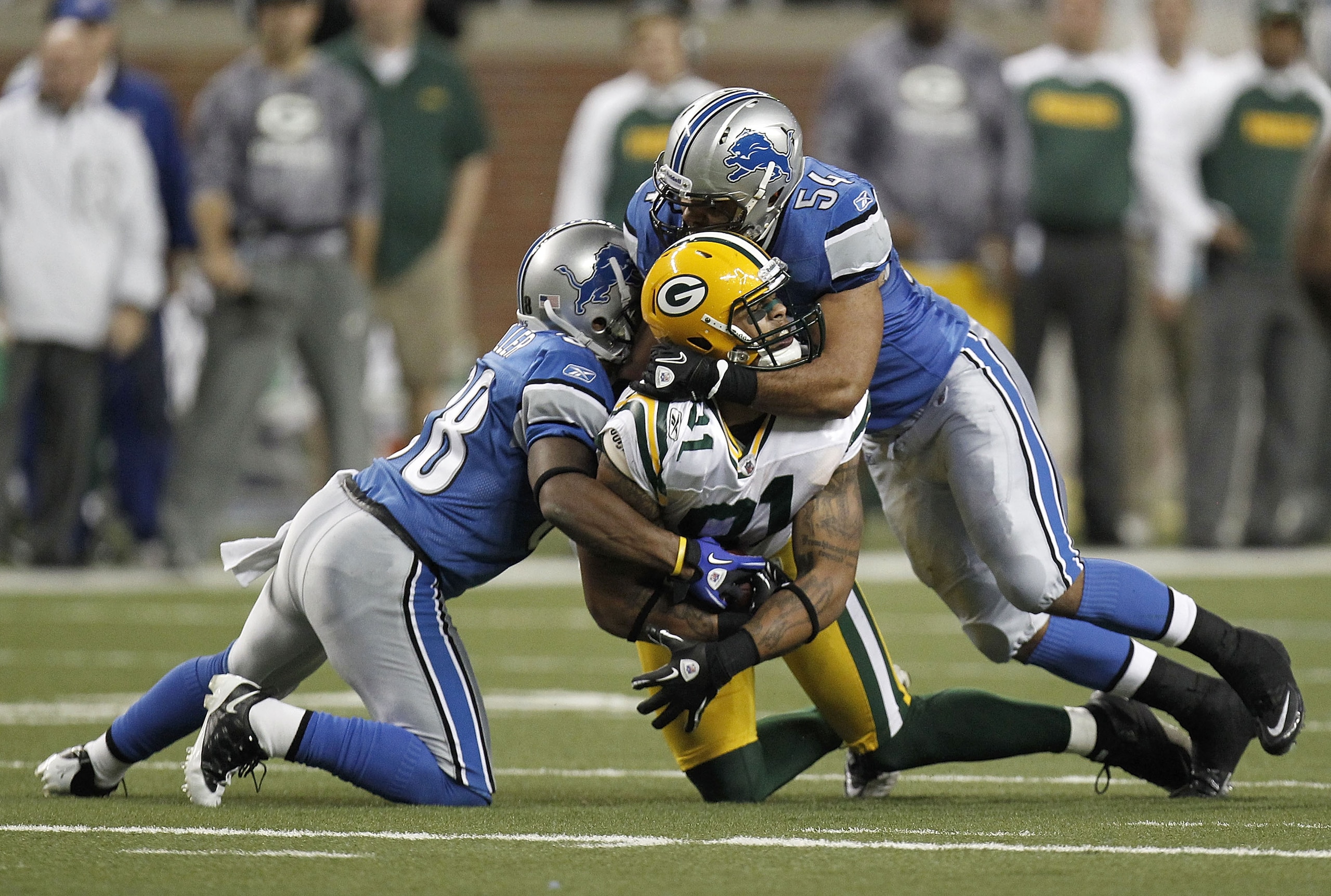 DETROIT, MI - DECEMBER 12: Andrew Quarless #81 of the Green Bay Packers is tackled by DeAndre Levy #54 and Prince Miller #38 of the Detroit Lions on December 12, 2010 at Ford Field in Detroit, Michigan. Detroit won the game 7-3. (Photo by Gregory Shamus/G DETROIT, MI - DECEMBER 12: Andrew Quarless #81 of the Green Bay Packers is tackled by DeAndre Levy #54 and Prince Miller #38 of the Detroit Lions on December 12, 2010 at Ford Field in Detroit, Michigan. Detroit won the game 7-3. (Photo by Gregory Shamus/G