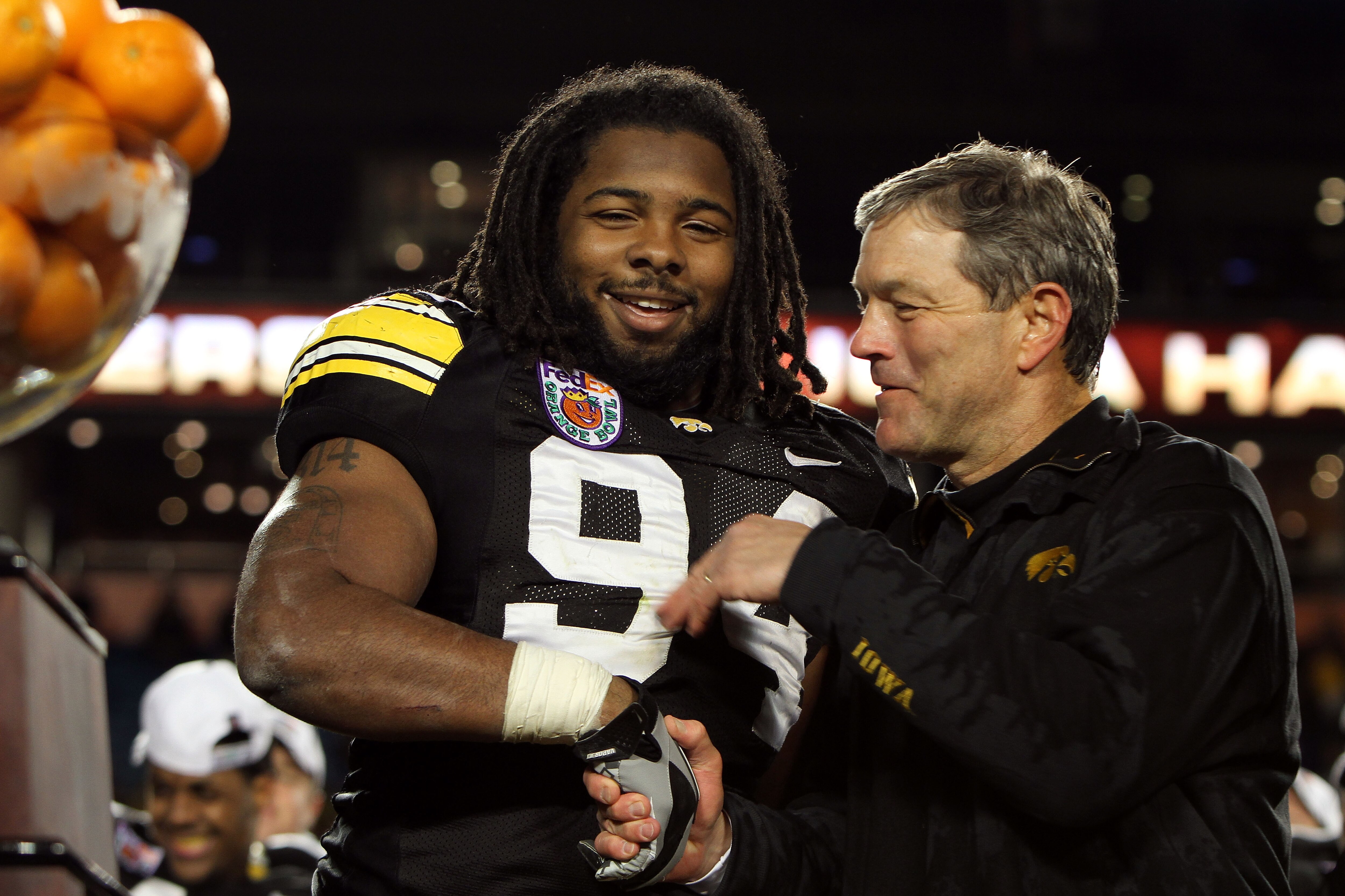 MIAMI GARDENS, FL - JANUARY 05:  (L-R) Adrian Clayborn #94 and head coach Kirk Ferentz of the Iowa Hawkeyes celebrate after their 24-14 win against the Georgia Tech Yellow Jackets during the FedEx Orange Bowl at Land Shark Stadium on January 5, 2010 in Mi