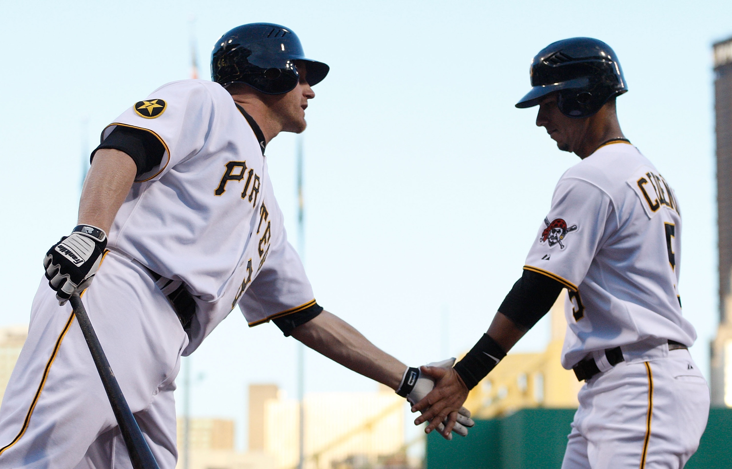 PITTSBURGH - MAY 09:  Ronny Cedeno #5 of the Pittsburgh Pirates is congratulated by teammate Lyle Overbay #37 after scoring against the Los Angeles Dodgers during the game on May 9, 2011 at PNC Park in Pittsburgh, Pennsylvania.  (Photo by Jared Wickerham/